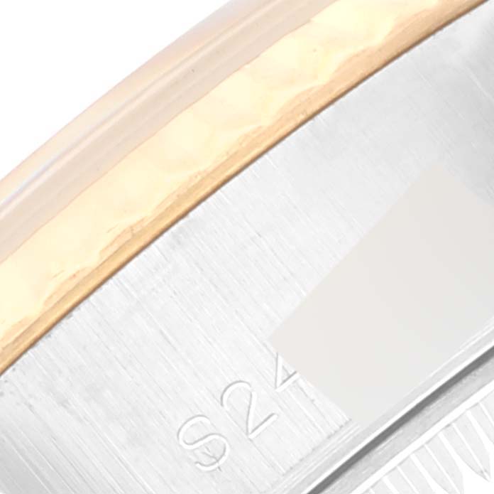 This image shows a close-up of the side of a Rolex Datejust 69173 Women
s Steel and Gold (two tone) Champagne Dial 69173 Women
s Steel and Gold (two tone) Champagne Dial watch showcasing part of the case with the serial number.