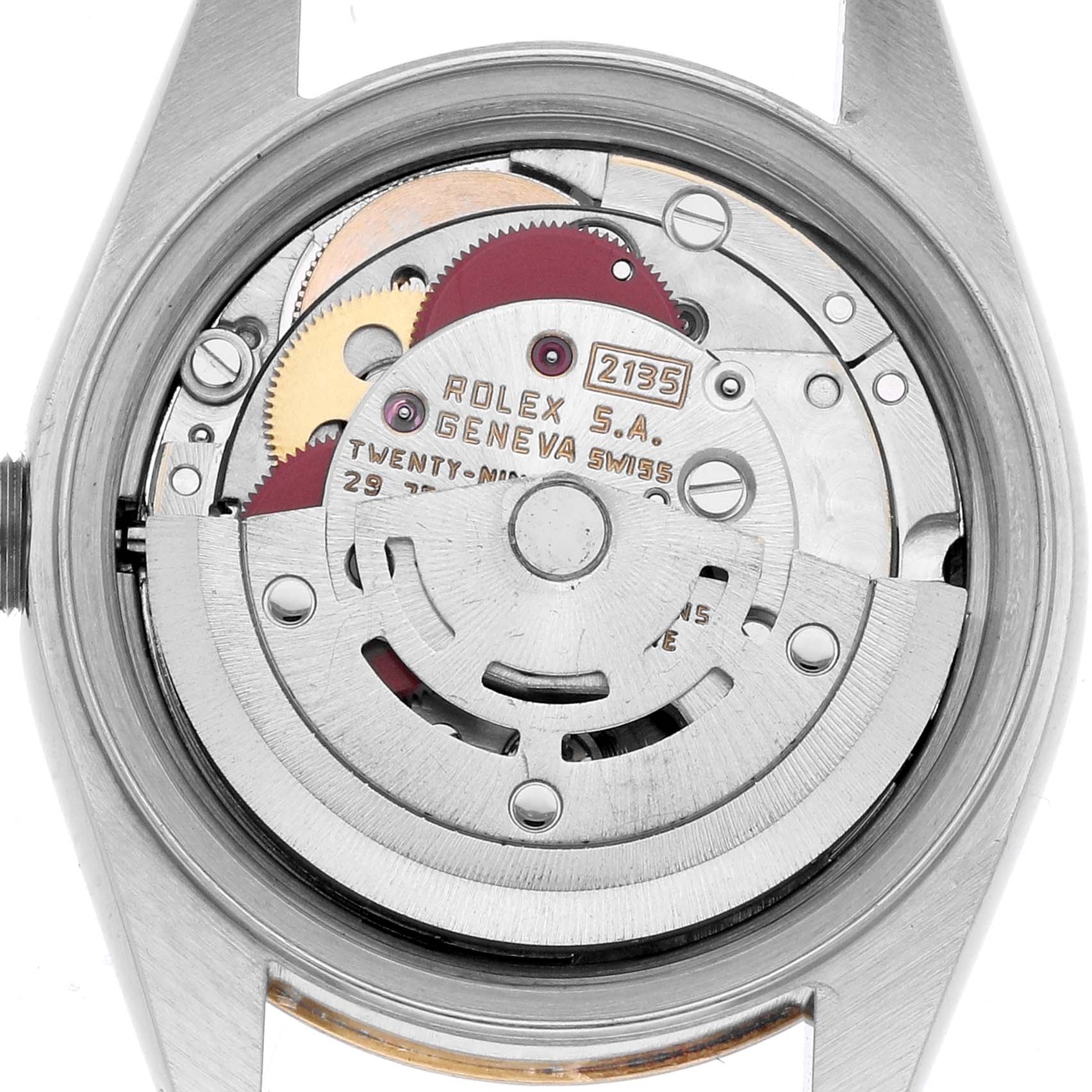 The image shows a Rolex Datejust 69173 Women
s Steel and Gold (two tone) Black Dial watch
s movement from a back angle, highlighting its intricate gears and rotor.