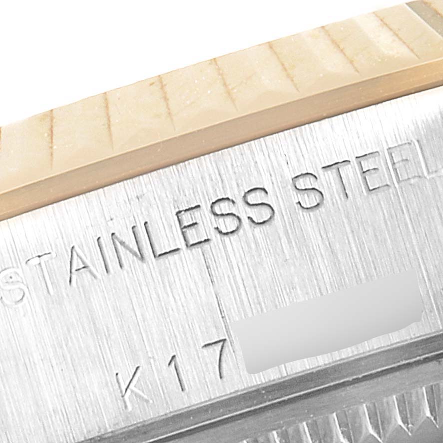 The image shows a close-up of the stainless steel case with engraved details from a Rolex Datejust 79173 Women's Steel and Gold (two tone) Champagne Dial 79173 Women's Steel and Gold (two tone) Champagne Dial model.