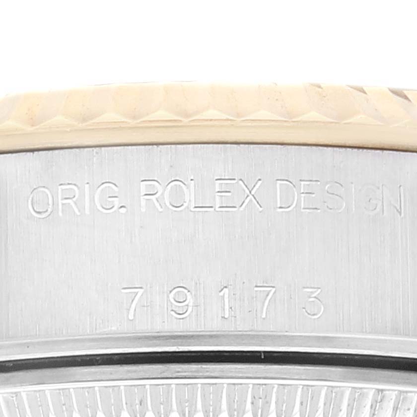 Close-up of the side engraving on a Rolex Datejust 79173 Women's Steel and Gold (two tone) Champagne Dial 79173 Women's Steel and Gold (two tone) Champagne Dial watch, showing "ORIG. ROLEX DESIGN" and the reference number.
