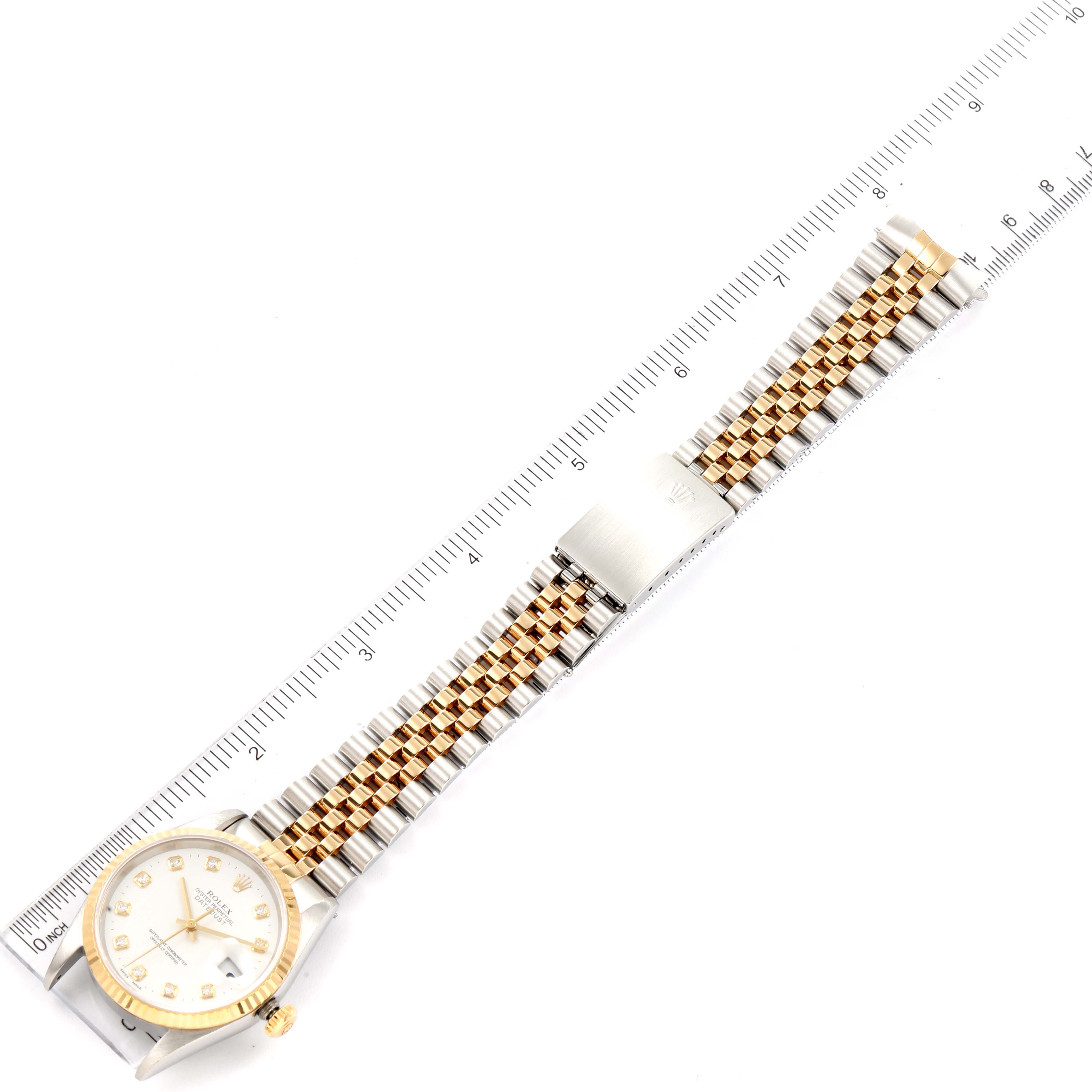 The image shows a Rolex Datejust 16233 Men's Steel and Gold (two tone) White Dial 16233 Men's Steel and Gold (two tone) White Dial watch and its entire bracelet, laid flat next to a ruler for measurement.