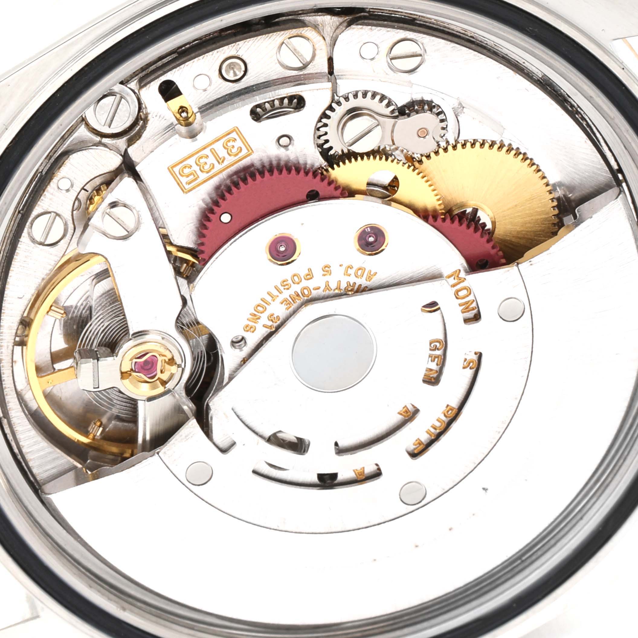 This image shows the intricate internal mechanics of the Rolex Datejust 16233 Men's Steel and Gold (two tone) White Dial 16233 Men's Steel and Gold (two tone) White Dial watch from the back angle, focusing on gears and movement components.