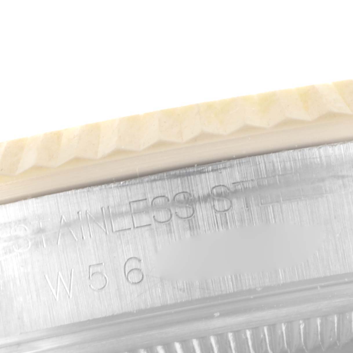 The image shows a close-up of the stainless steel case with engraved text and the fluted bezel of a Rolex Datejust 16233 Men's Steel and Gold (two tone) White Dial 16233 Men's Steel and Gold (two tone) White Dial watch.