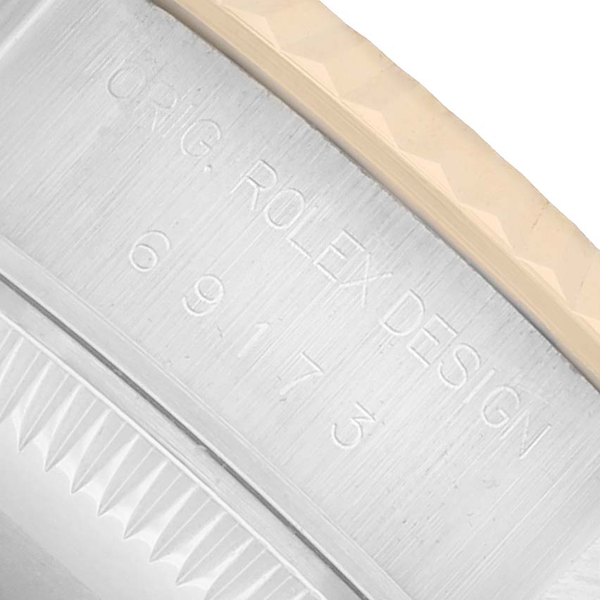 The image shows a close-up of the case side of a Rolex Datejust 69173 Women
s Steel and Gold (two tone) White Dial, highlighting the "Orig. Rolex Design" engraving.
