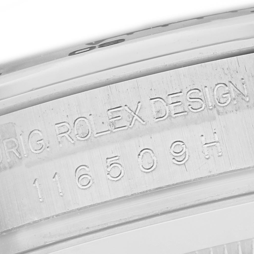 The image shows a close-up of the engraved serial number on the side of the case of a Rolex Daytona 116509 Men
s White Gold Silver Dial watch.