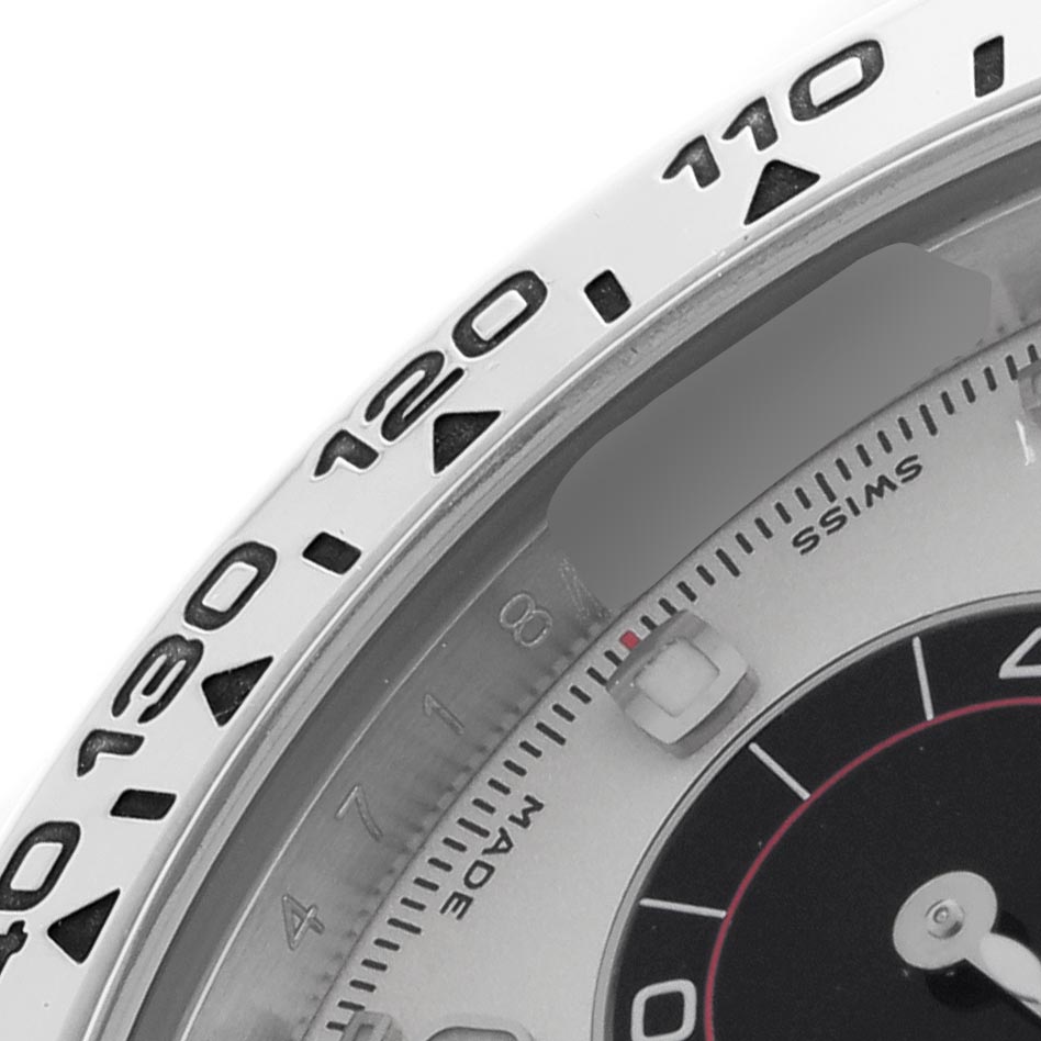 The image shows a close-up of the Rolex Daytona 116509 Men
s White Gold Silver Dial
s bezel and part of the dial, highlighting the tachymetric scale.
