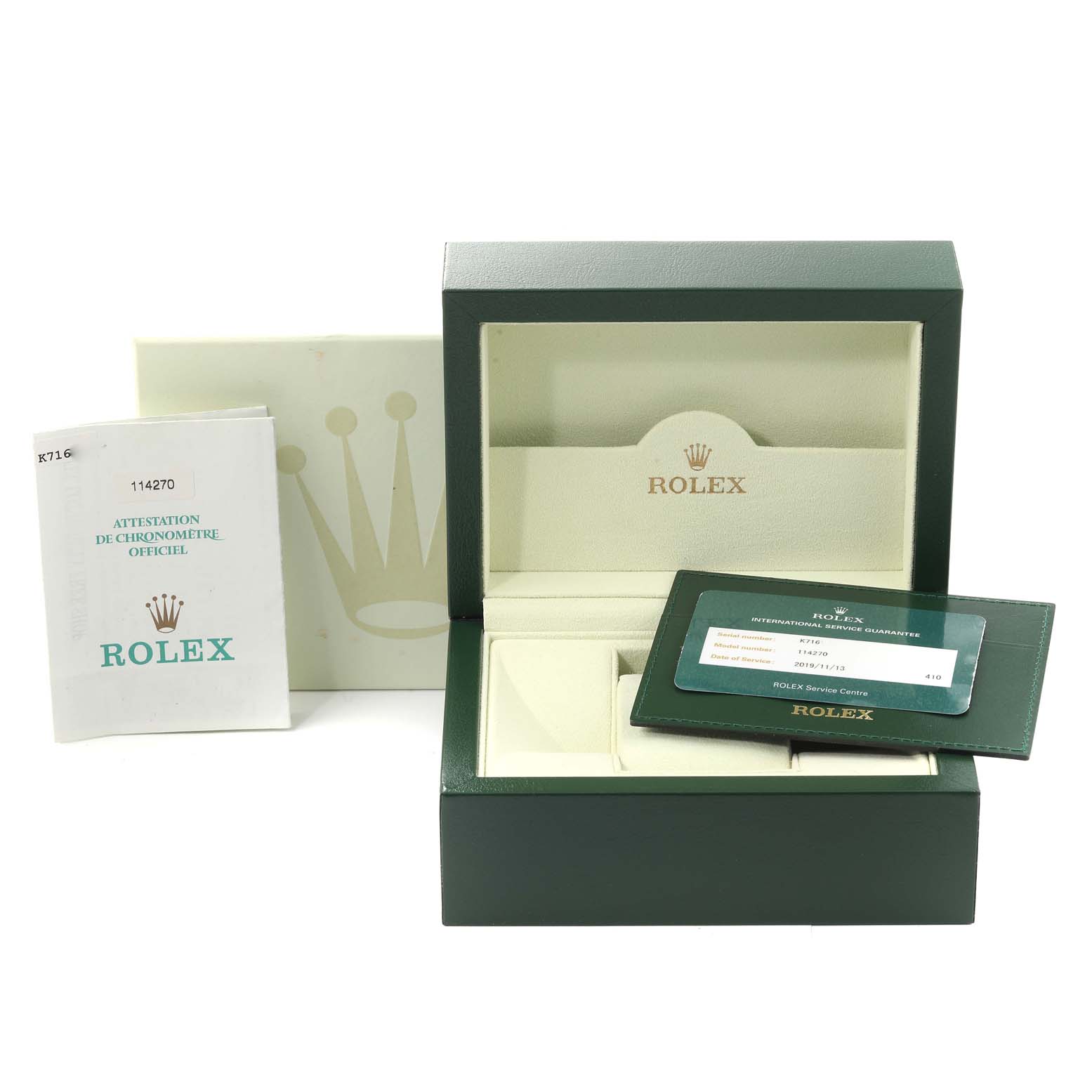 This image shows the packaging, guarantee card, and manual for a Rolex Explorer 114270 Men's Stainless Steel Black Dial 114270 Men's Stainless Steel Black Dial watch, model 114270.