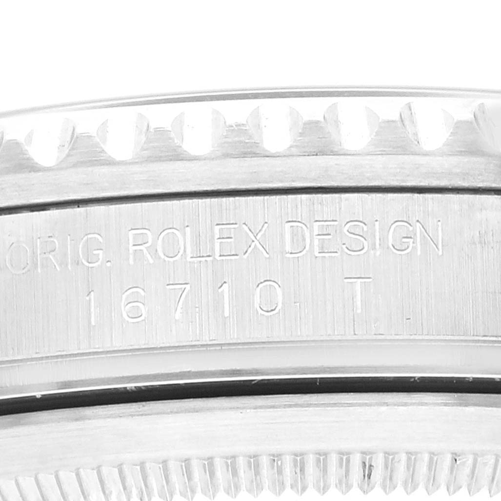 The image shows a close-up of the engraved bezel and lugs of a Rolex GMT-Master 16710 Men
s Stainless Steel Black Dial 16710 Men
s Stainless Steel Black Dial model 16710.
