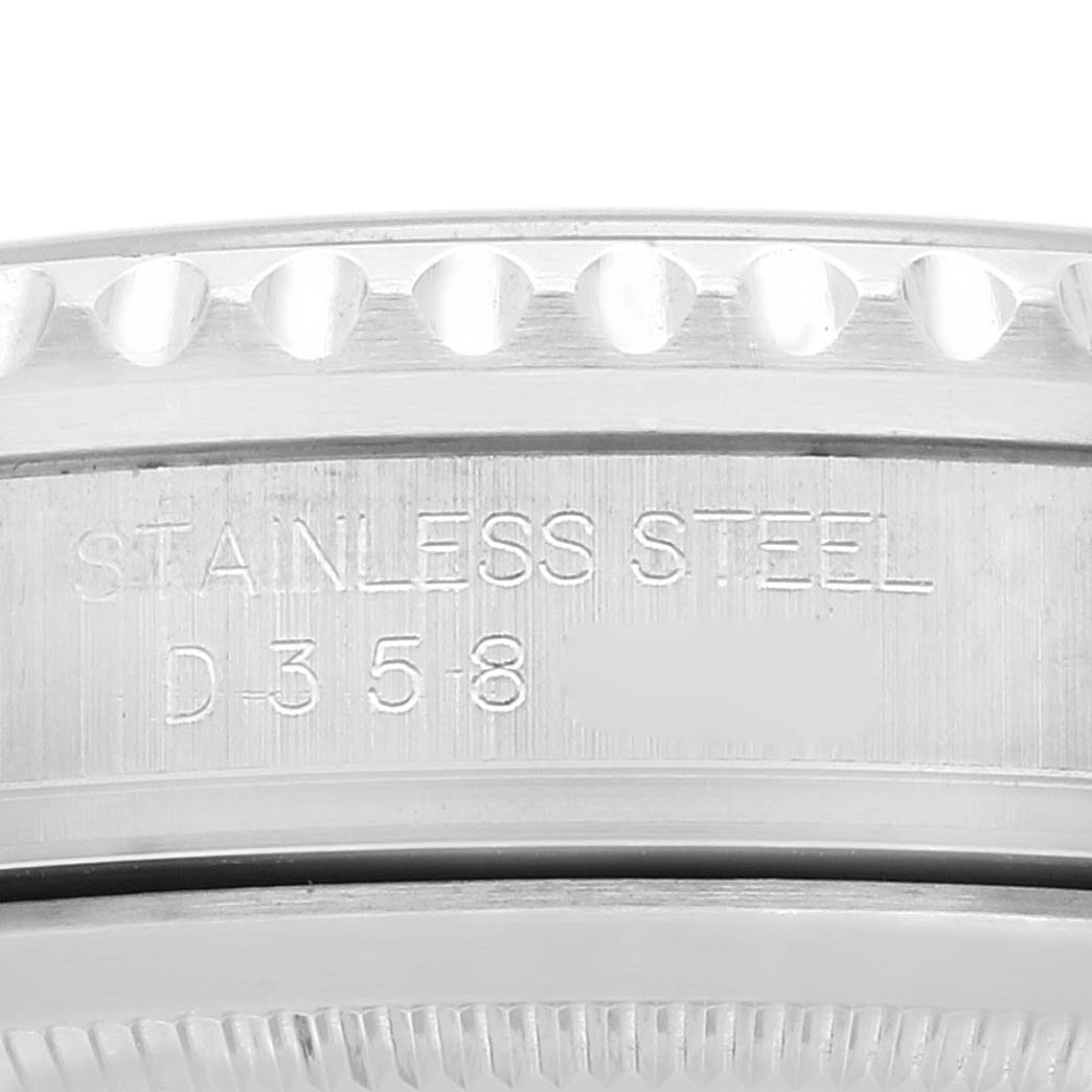 The image shows a close-up of the side case of a Rolex GMT-Master 16710 Men
s Stainless Steel Black Dial 16710 Men
s Stainless Steel Black Dial, highlighting its stainless steel material and engraved serial number.