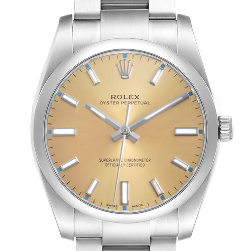 The Rolex Oyster Perpetual 114200 Men's Stainless Steel Champagne Dial watch is shown from the front, displaying the dial, bezel, and part of the bracelet.