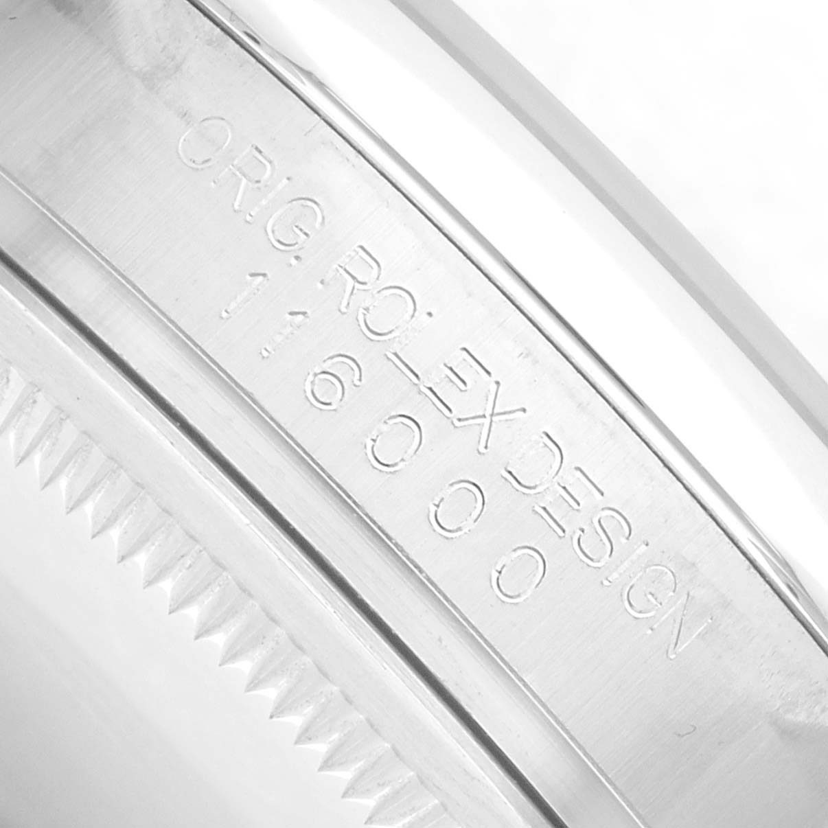 The image shows a close-up of the bezel and the engraved part of the Oyster Perpetual model by Rolex, highlighting the reference number.