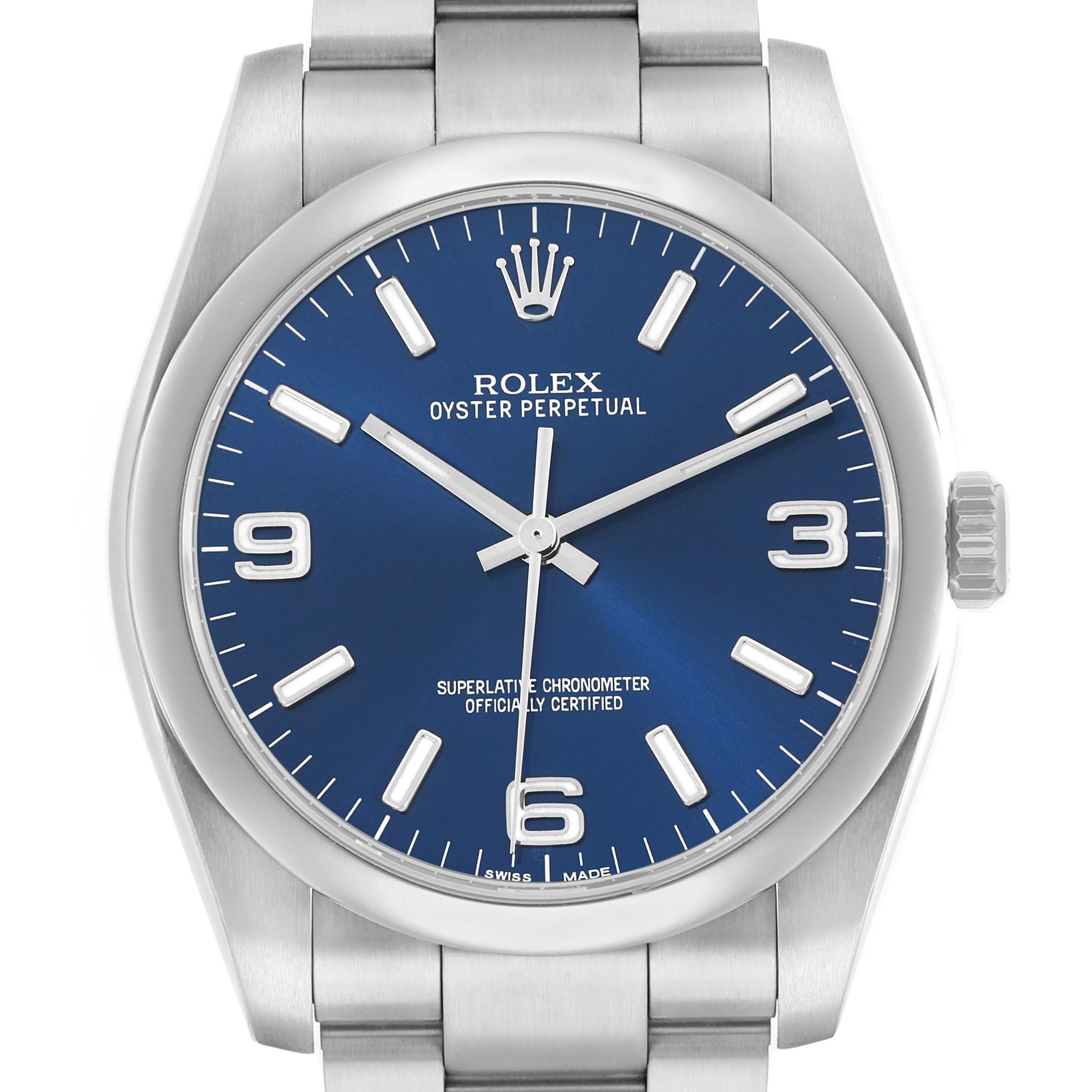 The Rolex Oyster Perpetual 116000 Men
s Stainless Steel Blue Dial watch is shown from the front, highlighting the blue dial, hour markers, hands, and crown.