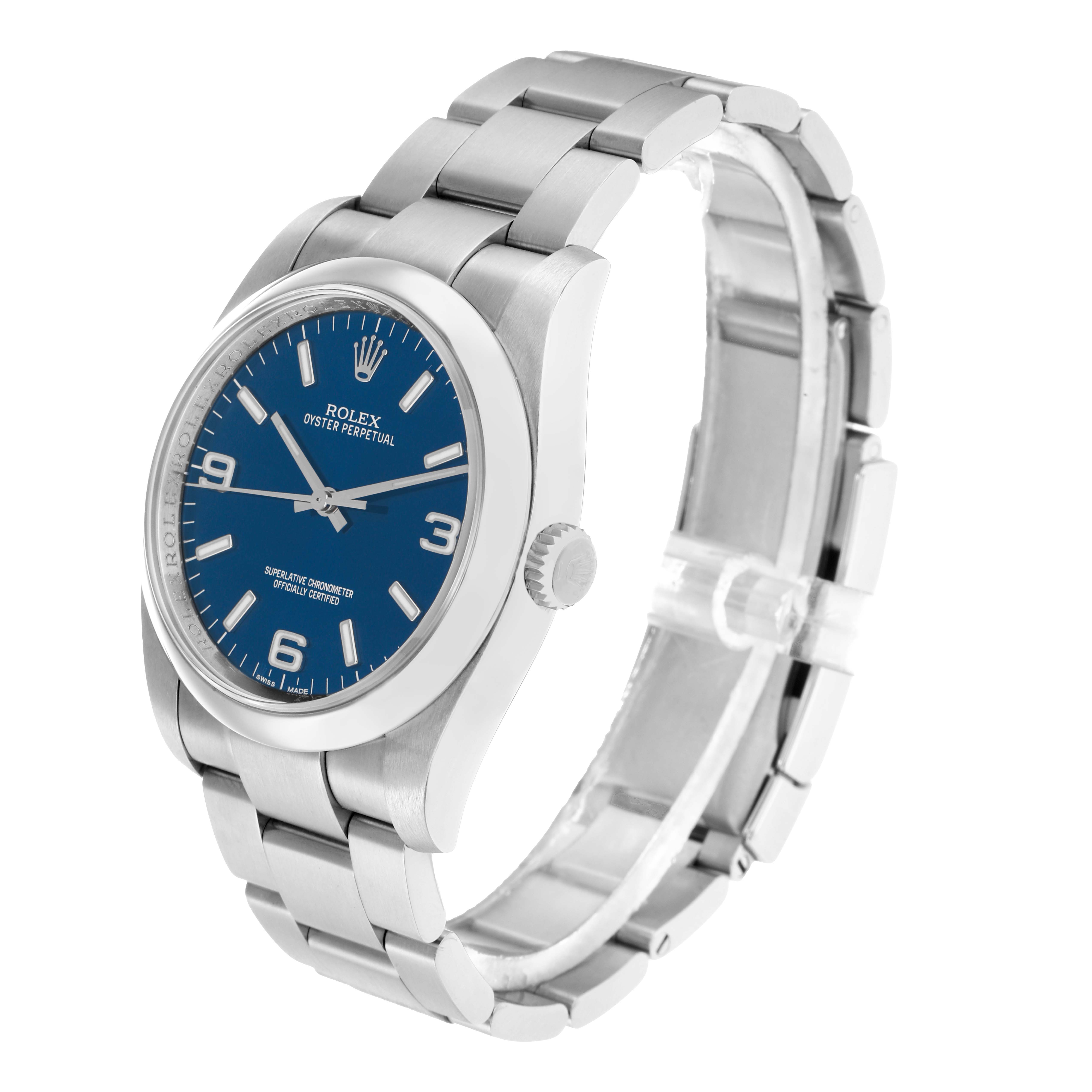 The image shows a side angle view of a Rolex Oyster Perpetual 116000 Men
s Stainless Steel Blue Dial, highlighting the blue dial, case, and bracelet.