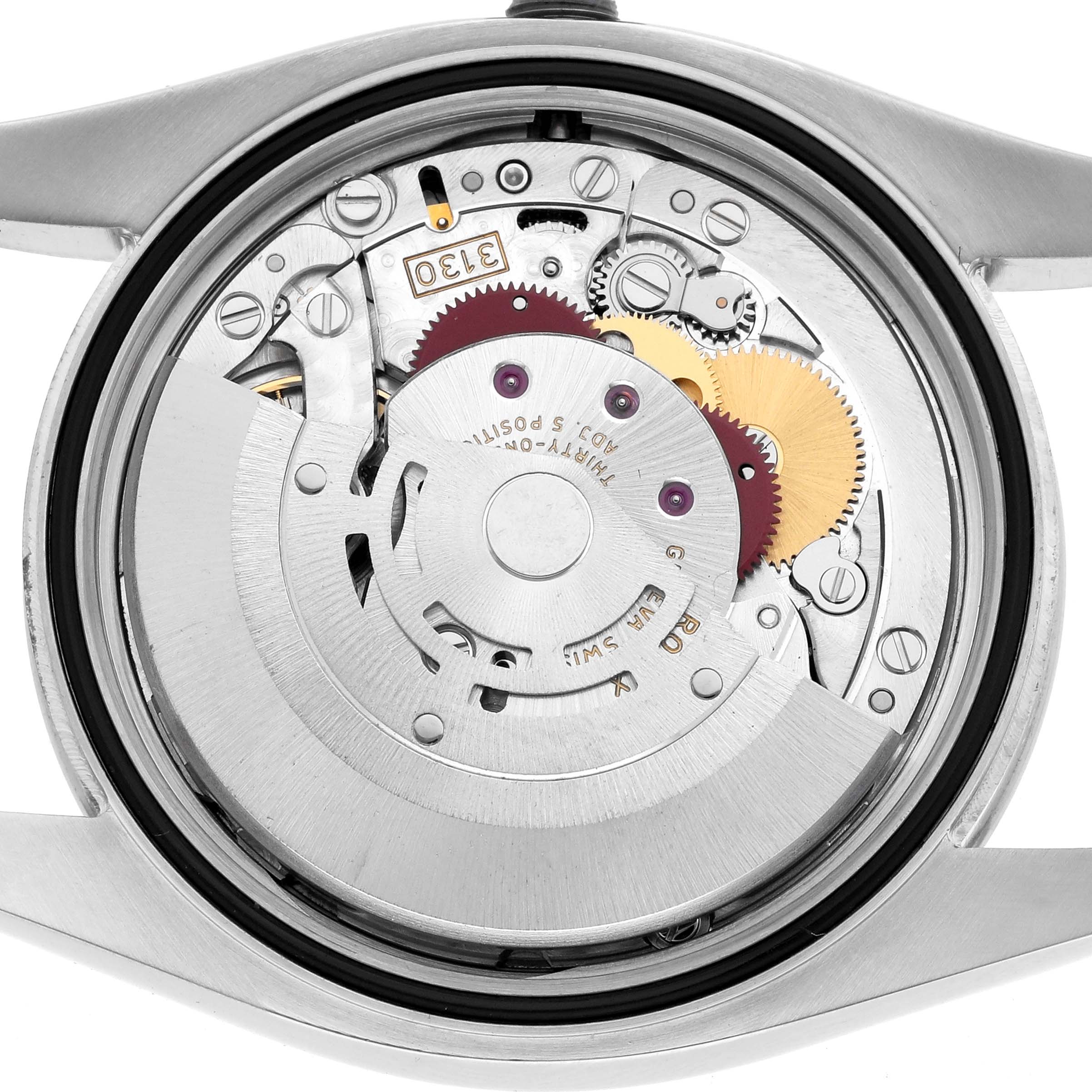 The image shows a close-up of the Rolex Oyster Perpetual 116000 Men
s Stainless Steel Blue Dial
s internal movement from the back, highlighting gears and mechanics.