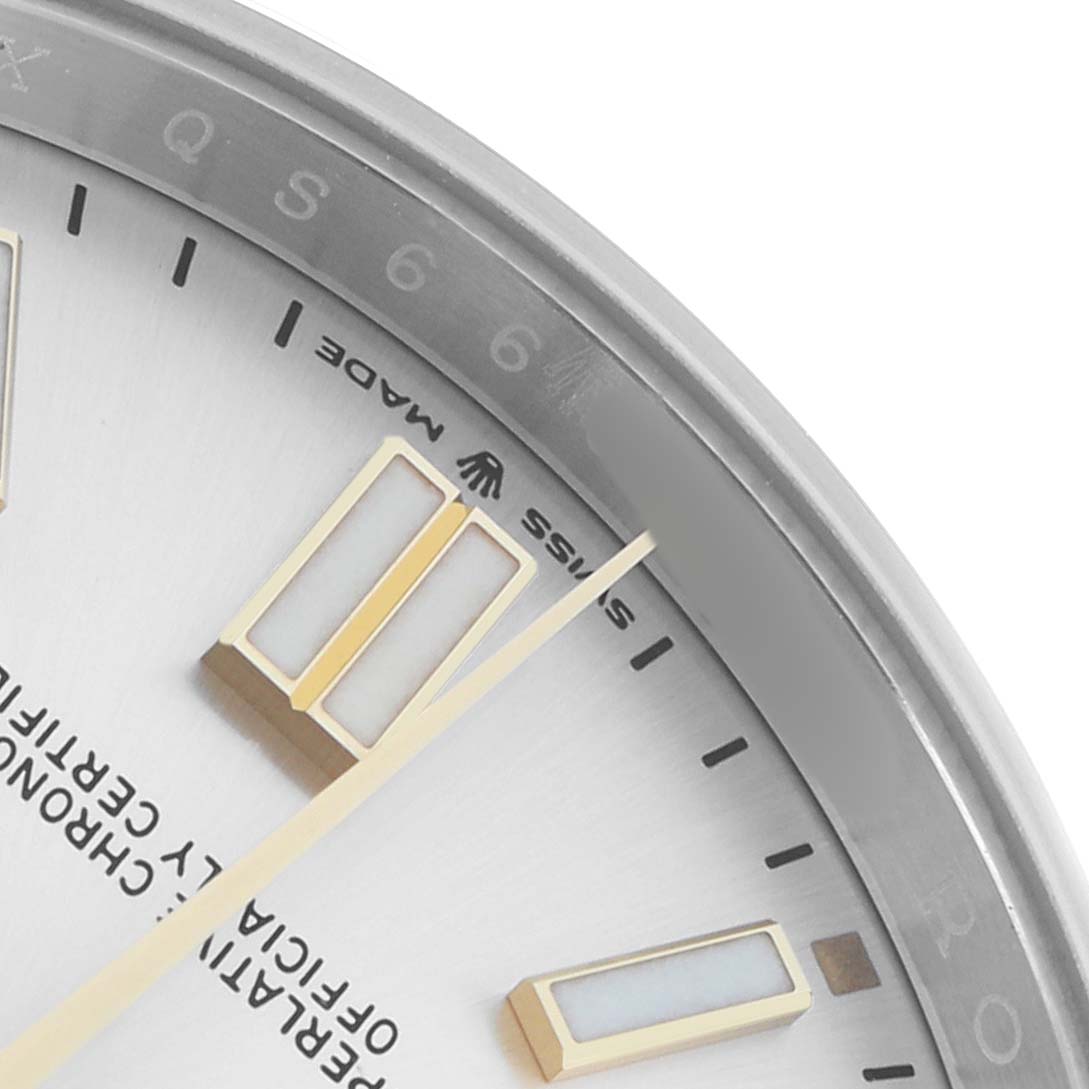The image shows a close-up of the dial and hour markers of a Rolex Oyster Perpetual 124300 Men
s Stainless Steel Silver Dial watch, shot from an angled top view.