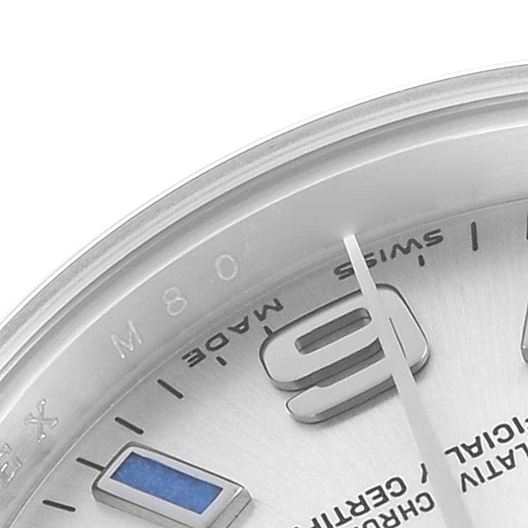 The image shows a close-up of the Rolex Oyster Perpetual 176200 Women
s Stainless Steel Silver Dial
s dial, focusing on the edge, hour markers, hands, and part of the bezel.