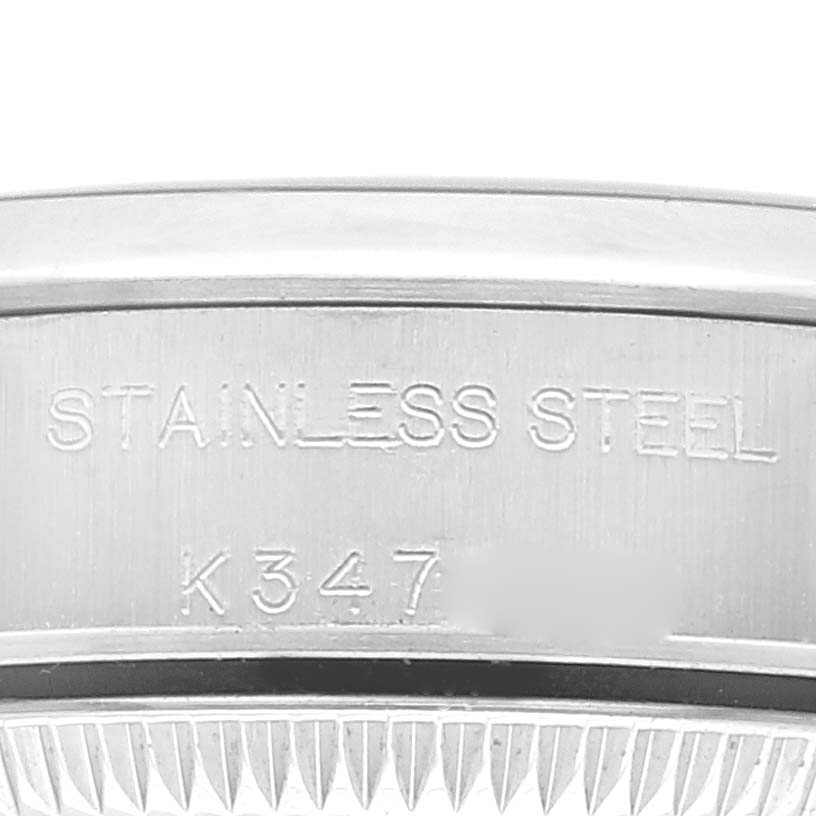 This image shows a close-up of the side engraving on the stainless steel band of a Rolex Oyster Perpetual 76080 Women
s Stainless Steel Blue Dial 76080 Women
s Stainless Steel Blue Dial watch.
