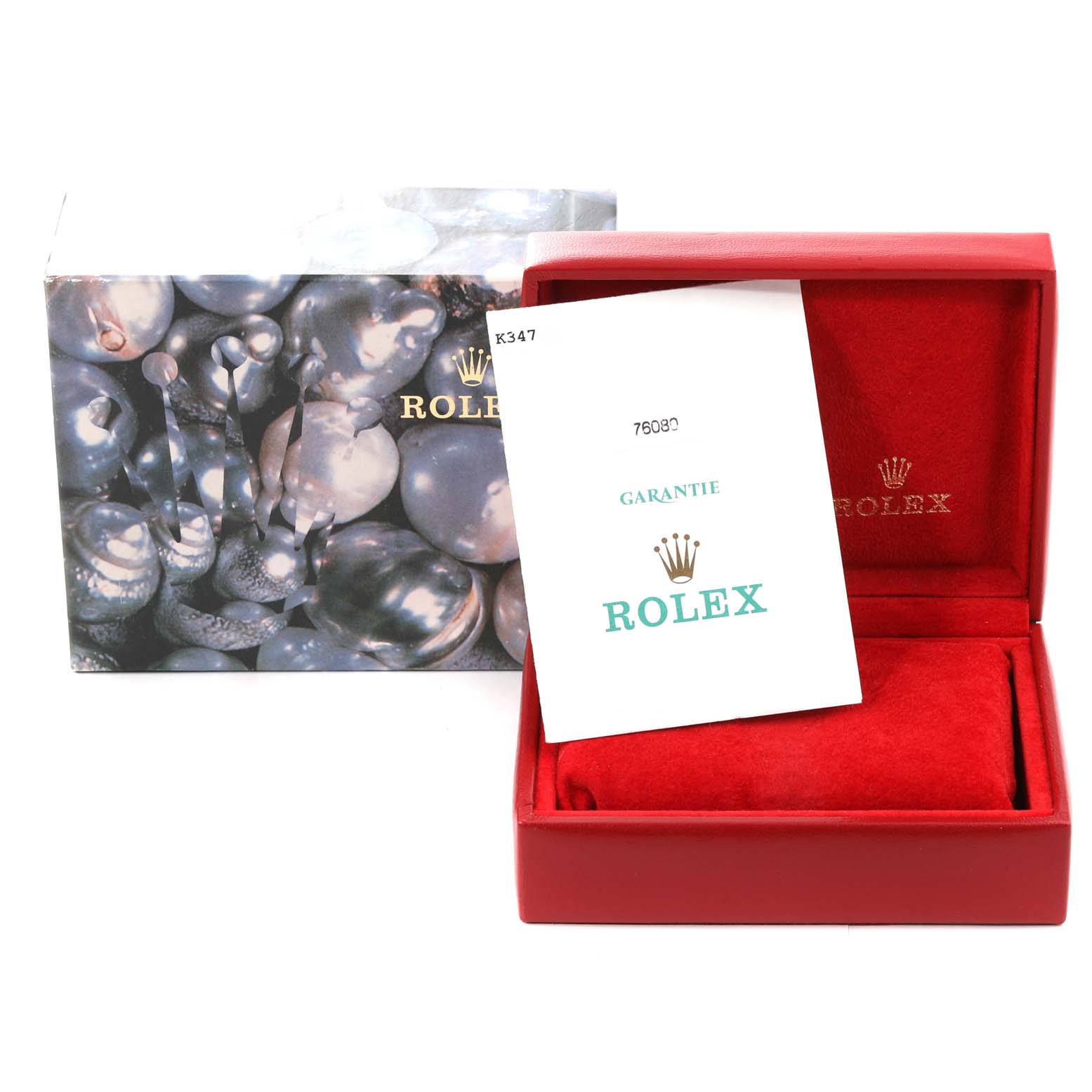 The image shows the packaging and guarantee paperwork for a Rolex Oyster Perpetual 76080 Women
s Stainless Steel Blue Dial 76080 Women
s Stainless Steel Blue Dial watch, including an outer box and a red inner box.