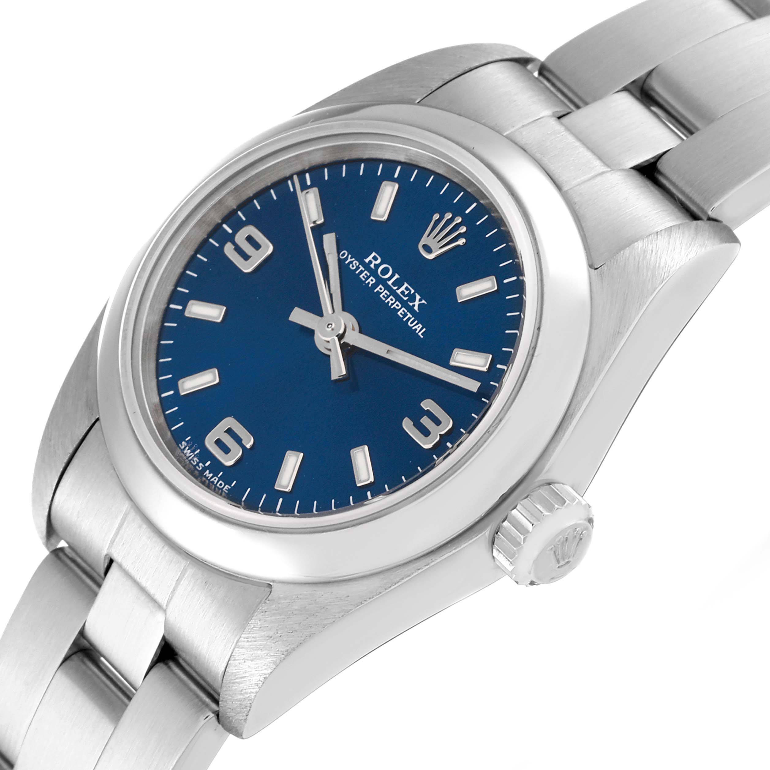 The Rolex Oyster Perpetual 76080 Women
s Stainless Steel Blue Dial 76080 Women
s Stainless Steel Blue Dial watch is shown from an angled perspective, displaying its face with a blue dial, crown, and part of the bracelet.