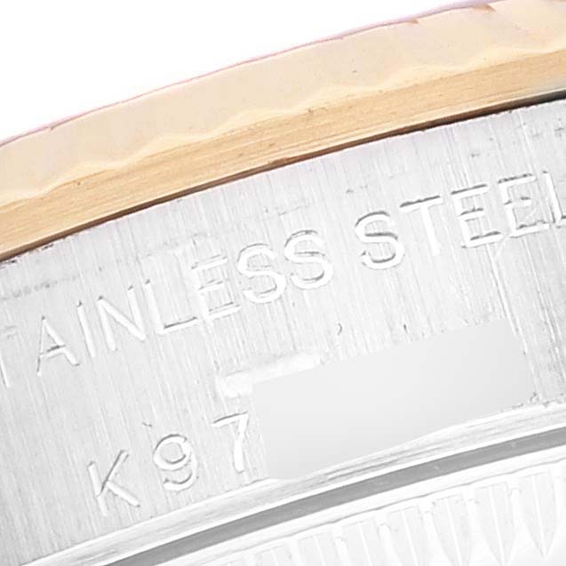 This close-up shows a portion of the caseback edge of a Rolex Oyster Perpetual 76193 Women's Steel and Gold (two tone) Black Dial 76193 Women's Steel and Gold (two tone) Black Dial, focusing on the stainless steel material marking.