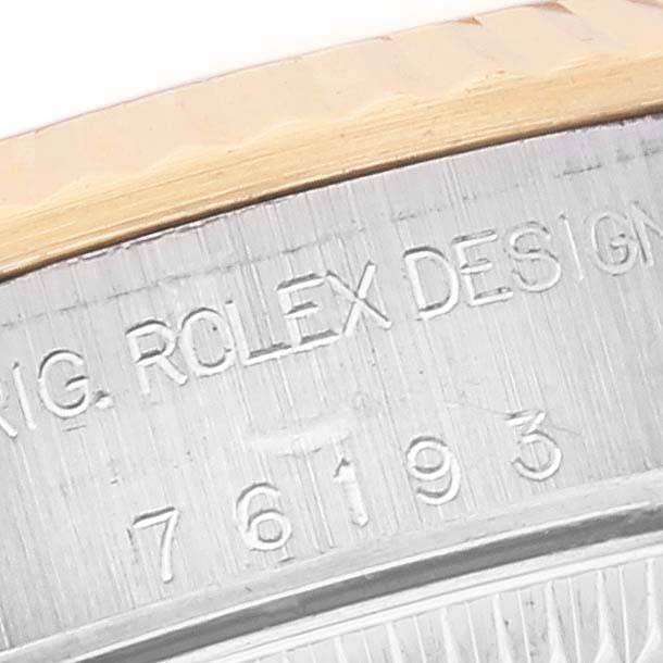 This image shows a close-up of the side engraving on a Rolex Oyster Perpetual 76193 Women's Steel and Gold (two tone) Black Dial 76193 Women's Steel and Gold (two tone) Black Dial watch.