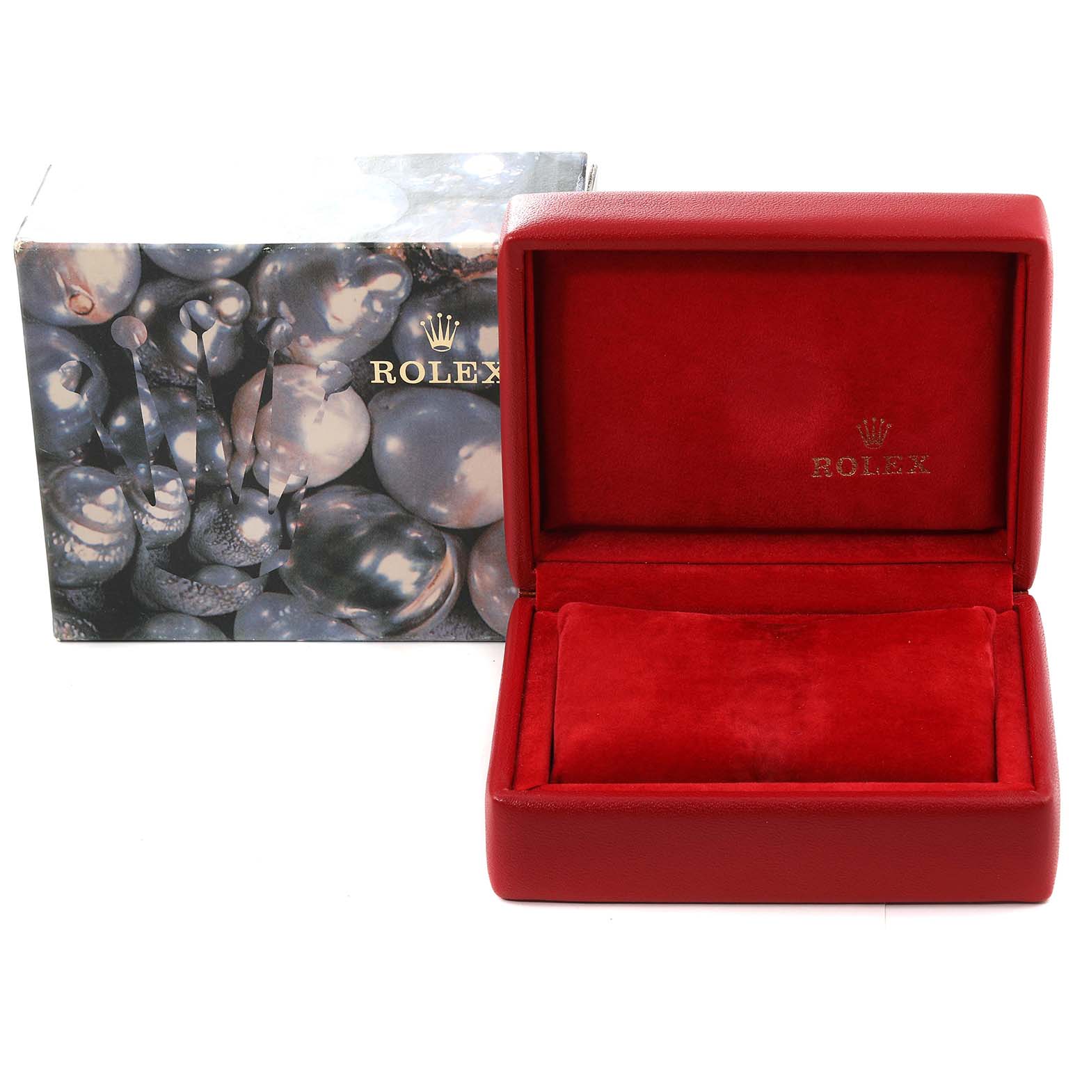 The image shows a red Rolex watch box for the Oyster Perpetual model, with the outer packaging visible behind it.