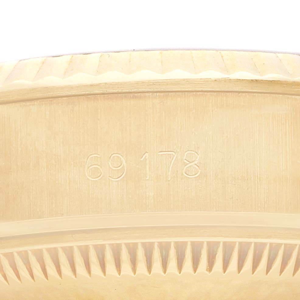 The image shows a close-up of the Rolex President 69178 Women
s Yellow Gold Blue Dial model
s case side, focusing on the engraved model number.