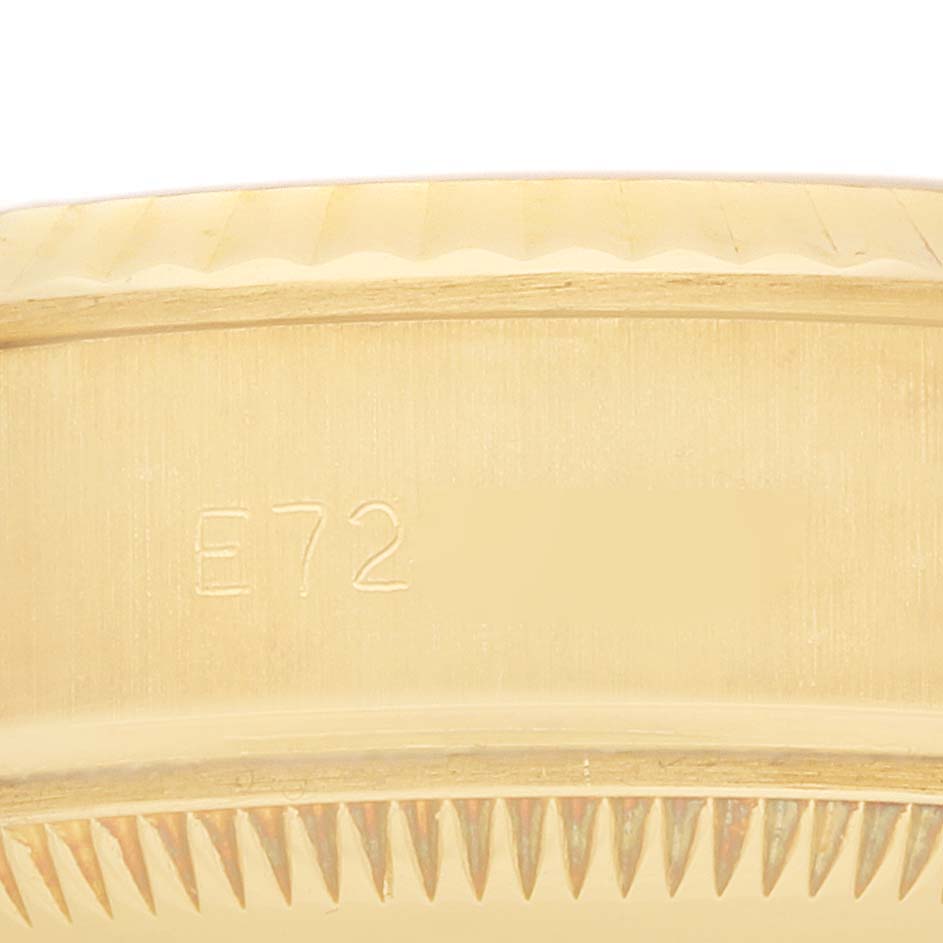 This image shows a close-up of the edge of the bezel and case of a Rolex President 69178 Women
s Yellow Gold Blue Dial model.