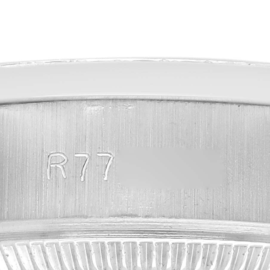 The image shows a close-up of the Rolex President 69136 Men
s Platinum Silver Dial model
s case with visible engravings.
