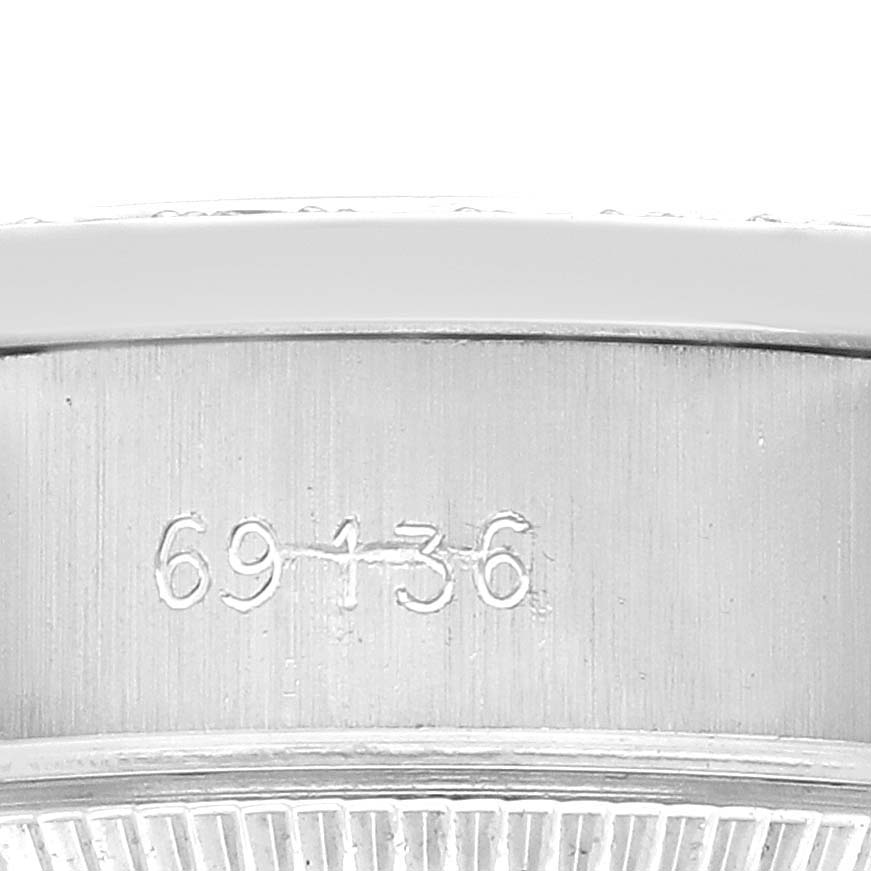 The image shows a close-up of the side case detailing with visible engravings on the Rolex President 69136 Men
s Platinum Silver Dial model watch.