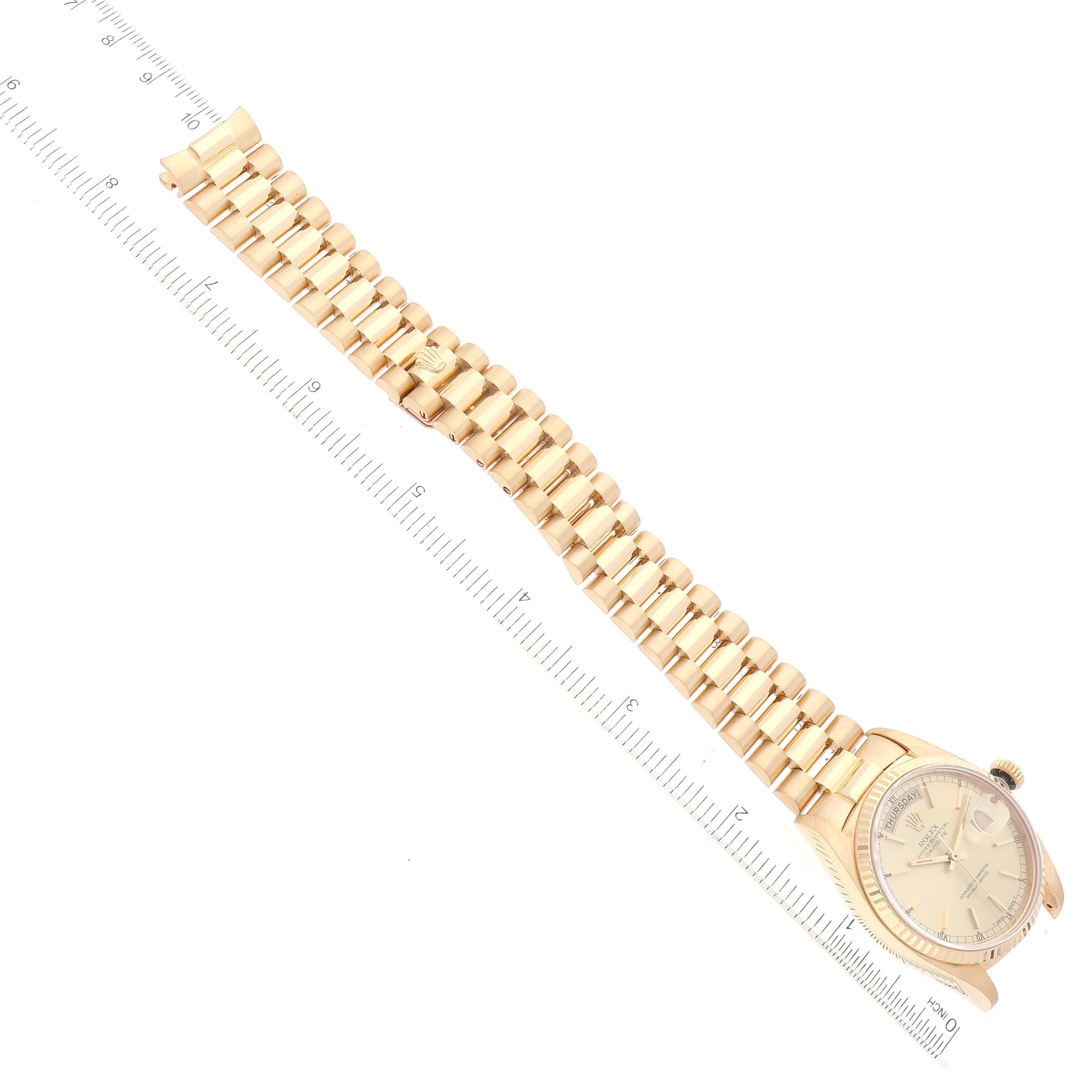 The Rolex President 18038 Men
s Yellow Gold Champagne Dial 18038 Men
s Yellow Gold Champagne Dial model watch is shown at an angle, displaying its face, dial, and full bracelet alongside a ruler for scale.