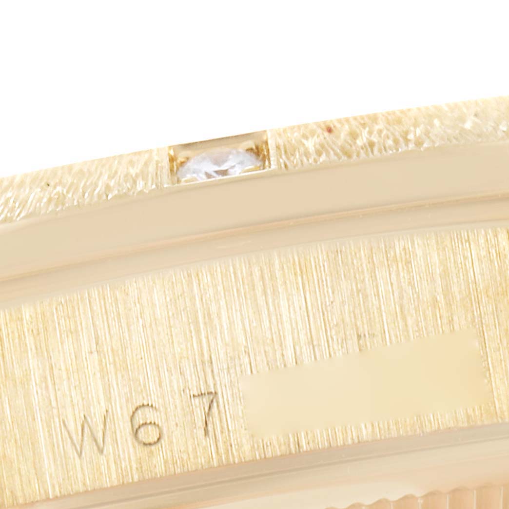 This image shows a close-up view of the serial number and diamond detail on the bezel of a Rolex President 18308 Men's Yellow Gold Beige Dial 18308 Men's Yellow Gold Beige Dial model watch.