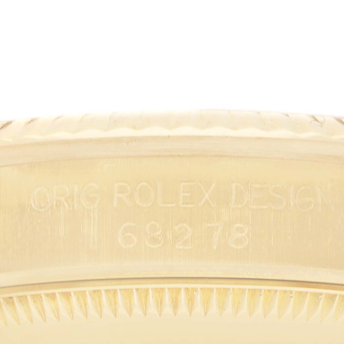 This image shows a close-up of the side engraving on the bezel of a Rolex President 68278 Women
s Yellow Gold Black Dial watch model.