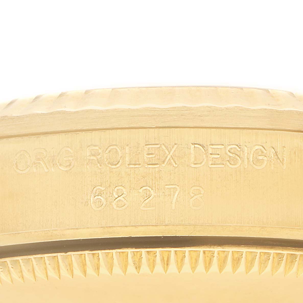 The image shows the side profile of a Rolex President 68278 Women
s Yellow Gold Blue Dial model, highlighting the engraved design and case edge.