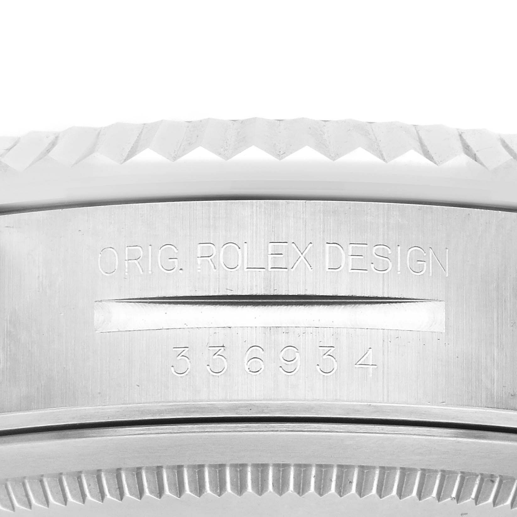 The image shows a close-up of the case side of a Rolex Sky-Dweller 336934 Men
s Stainless Steel Green Dial, highlighting the serrated bezel and engraved serial number.