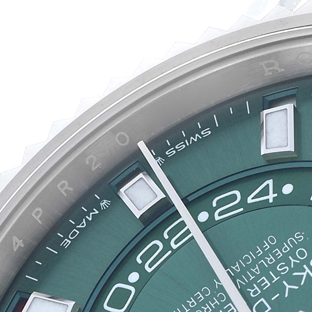 The image shows a close-up of the Rolex Sky-Dweller 336934 Men
s Stainless Steel Green Dial, highlighting part of the green face, markers, and edge of the bezel.
