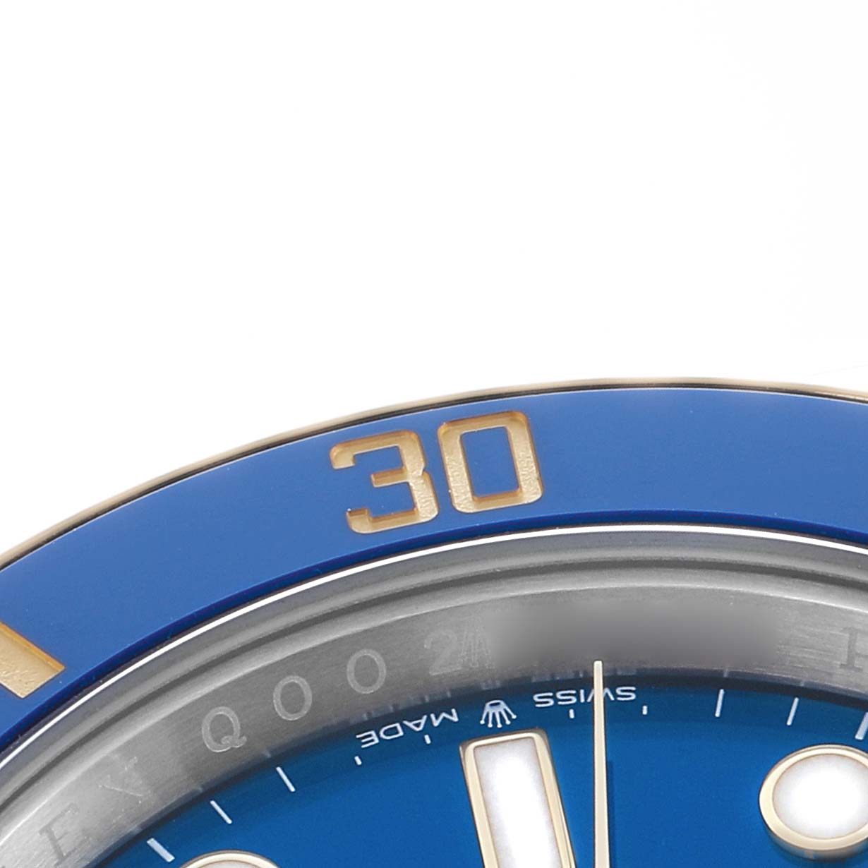 The image shows a close-up of the Rolex Submariner 126613 Men
s Steel and Gold (two tone) Blue Dial
s blue bezel and part of the dial with gold accents at an angle highlighting the "30" marker.