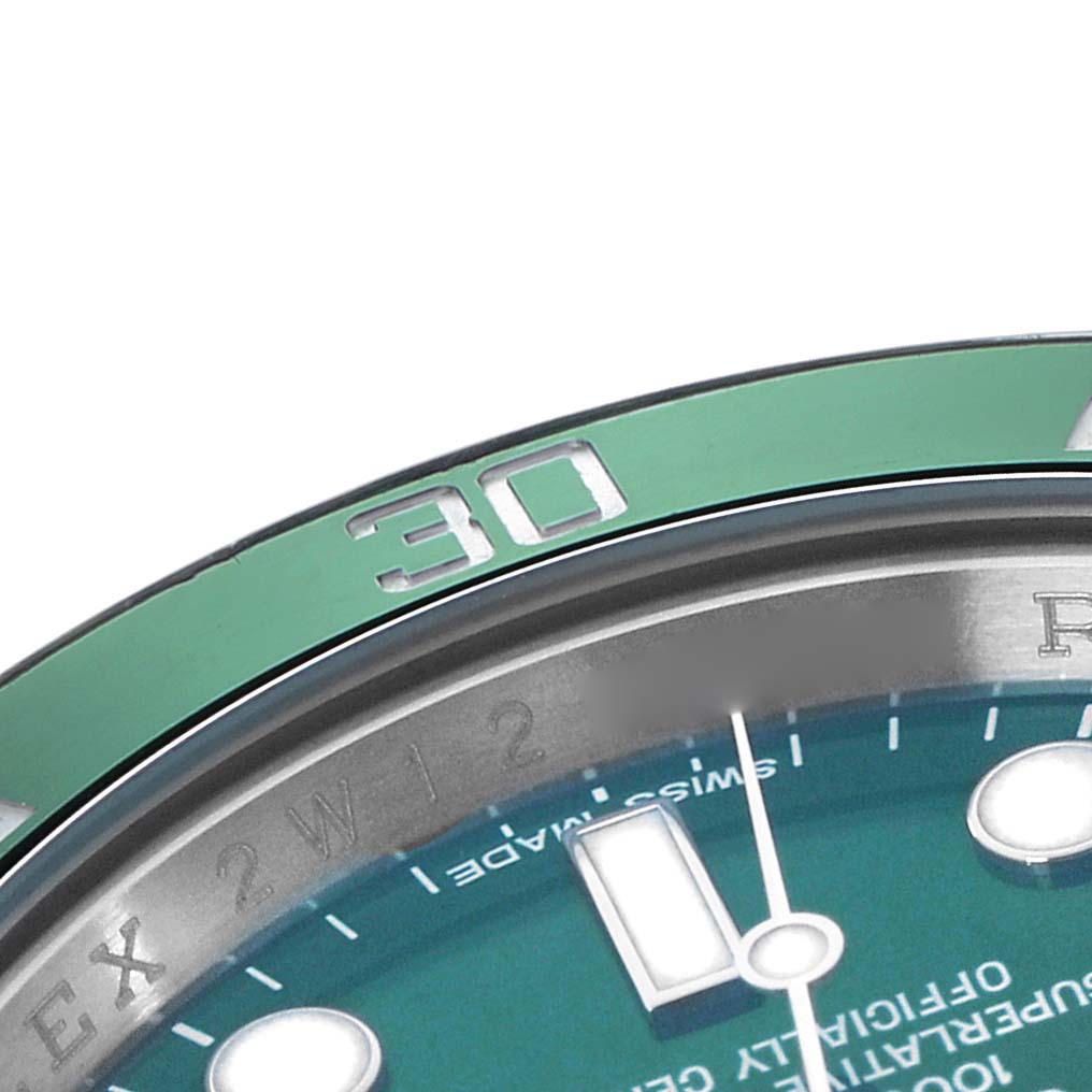 The image shows a close-up of a Rolex Submariner 116610LV Men
s Stainless Steel Green Dial
s bezel, displaying the number "30," and part of the dial and markers.
