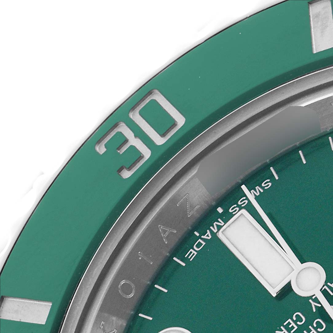 The image shows a close-up of the bezel and a portion of the dial of a Rolex Submariner 116610LV Men
s Stainless Steel Green Dial watch.