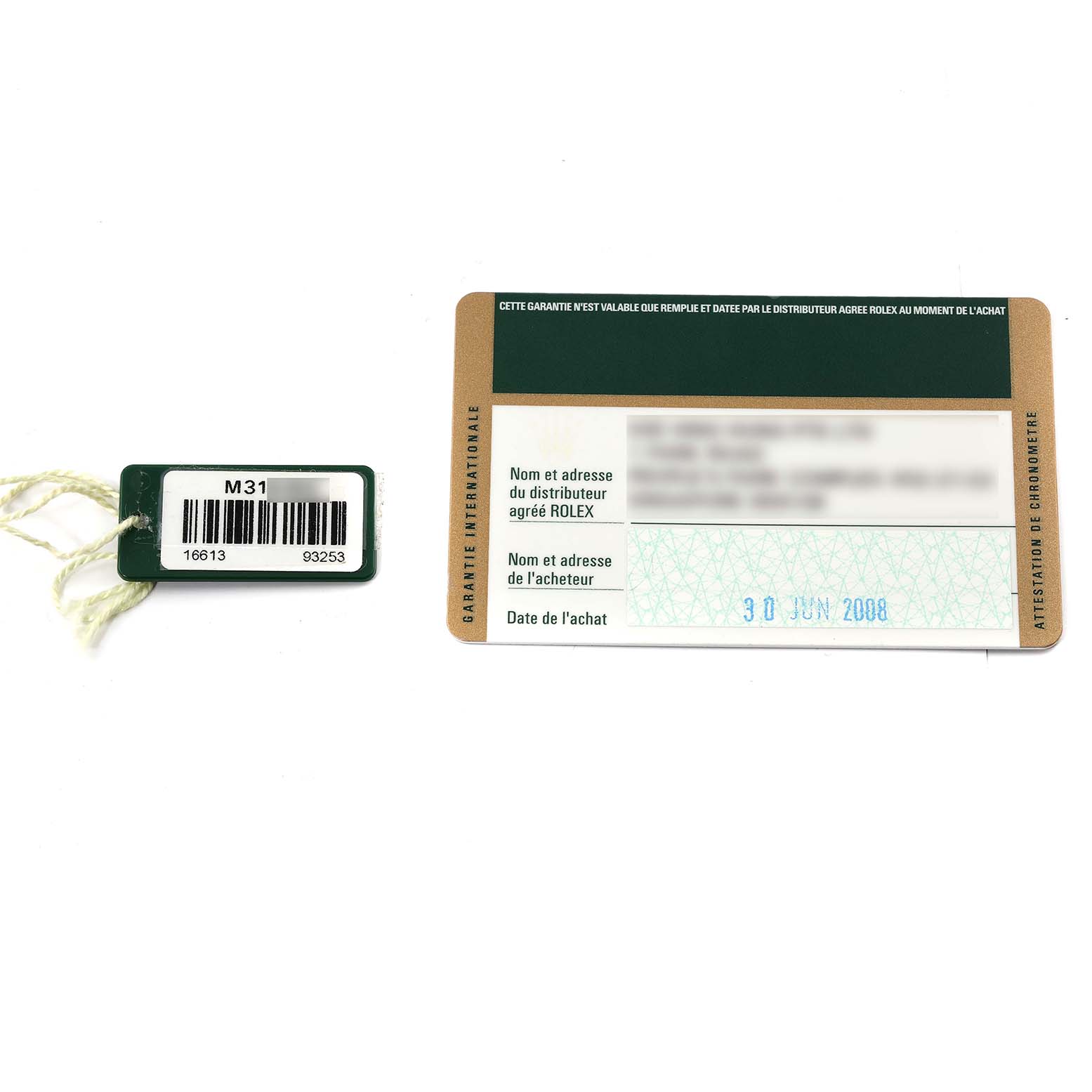 The image shows a warranty card and a barcode tag for the Rolex Submariner 16613 Men's Steel and Gold (two tone) Champagne Dial 16613 Men's Steel and Gold (two tone) Champagne Dial model, viewed from above.