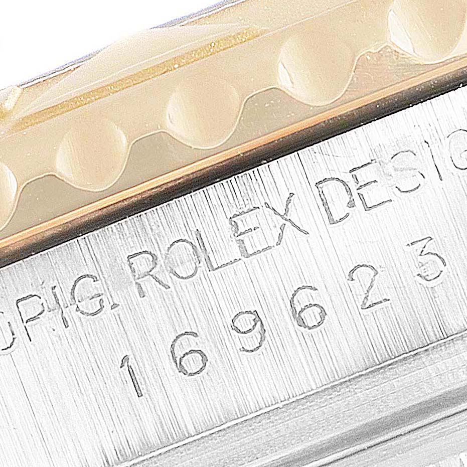 The image shows a close-up of the Rolex Yacht-Master 169623 Women's Steel and Gold (two tone) White Dial 169623 Women's Steel and Gold (two tone) White Dial model's engraved bezel and serial numbers.