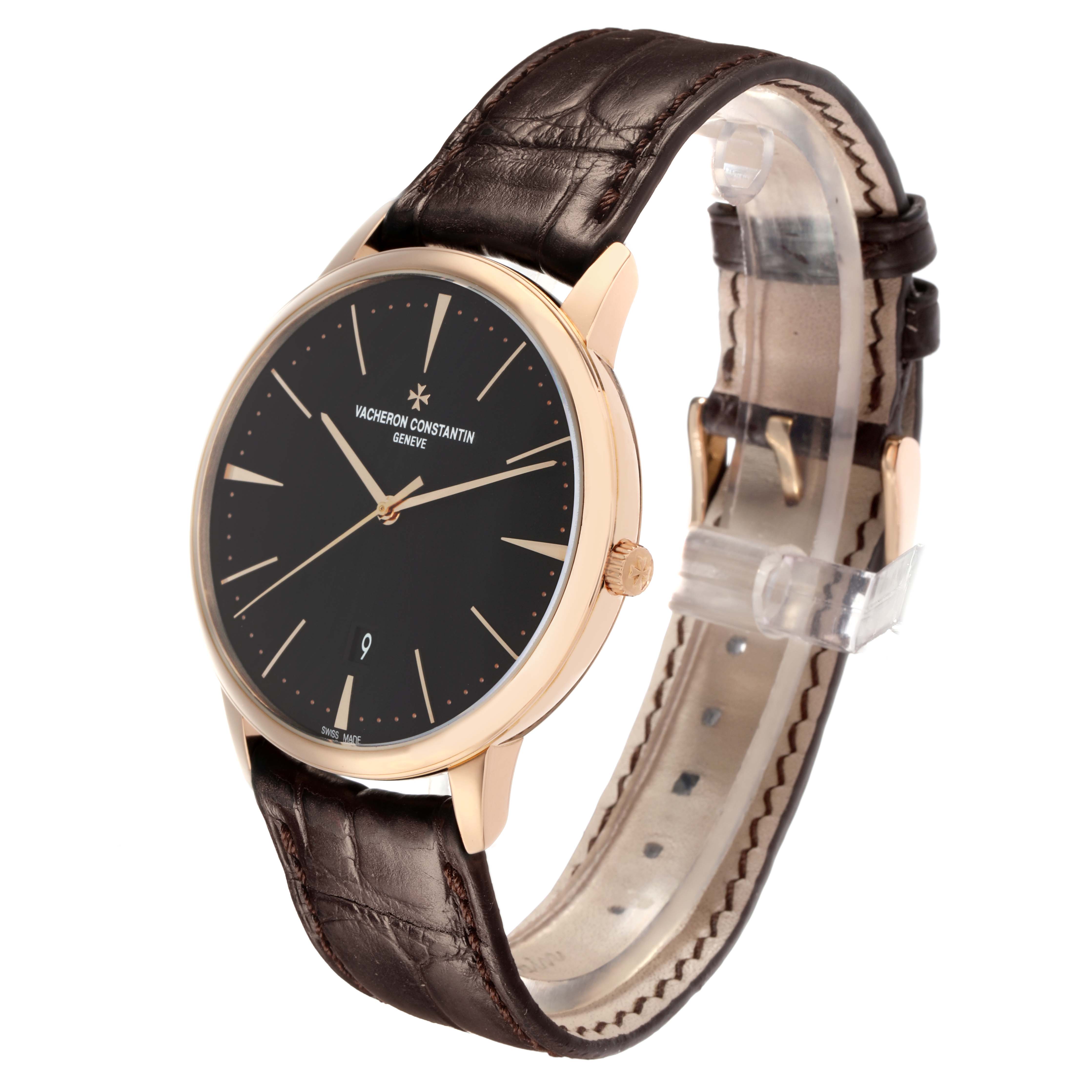 The image shows a Vacheron Constantin Patrimony 85180 Men
s Rose Gold Black Dial watch at an angled view, highlighting its face, crown, and leather strap.