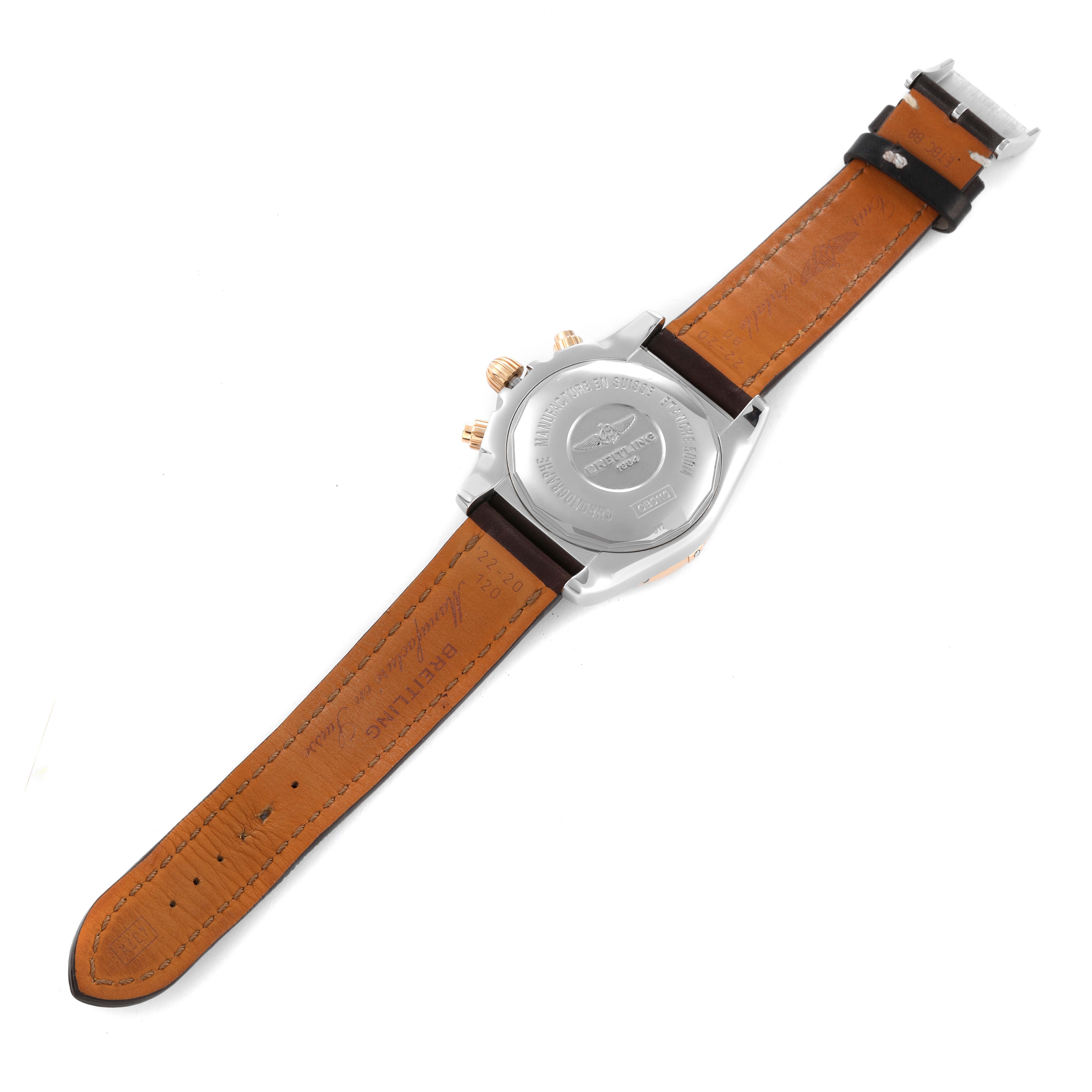 The image shows the back of a Breitling Chronomat CB0110 Men's Steel and Gold (two tone) Black Dial CB0110 Men's Steel and Gold (two tone) Black Dial watch, highlighting its leather strap and engraved case back.