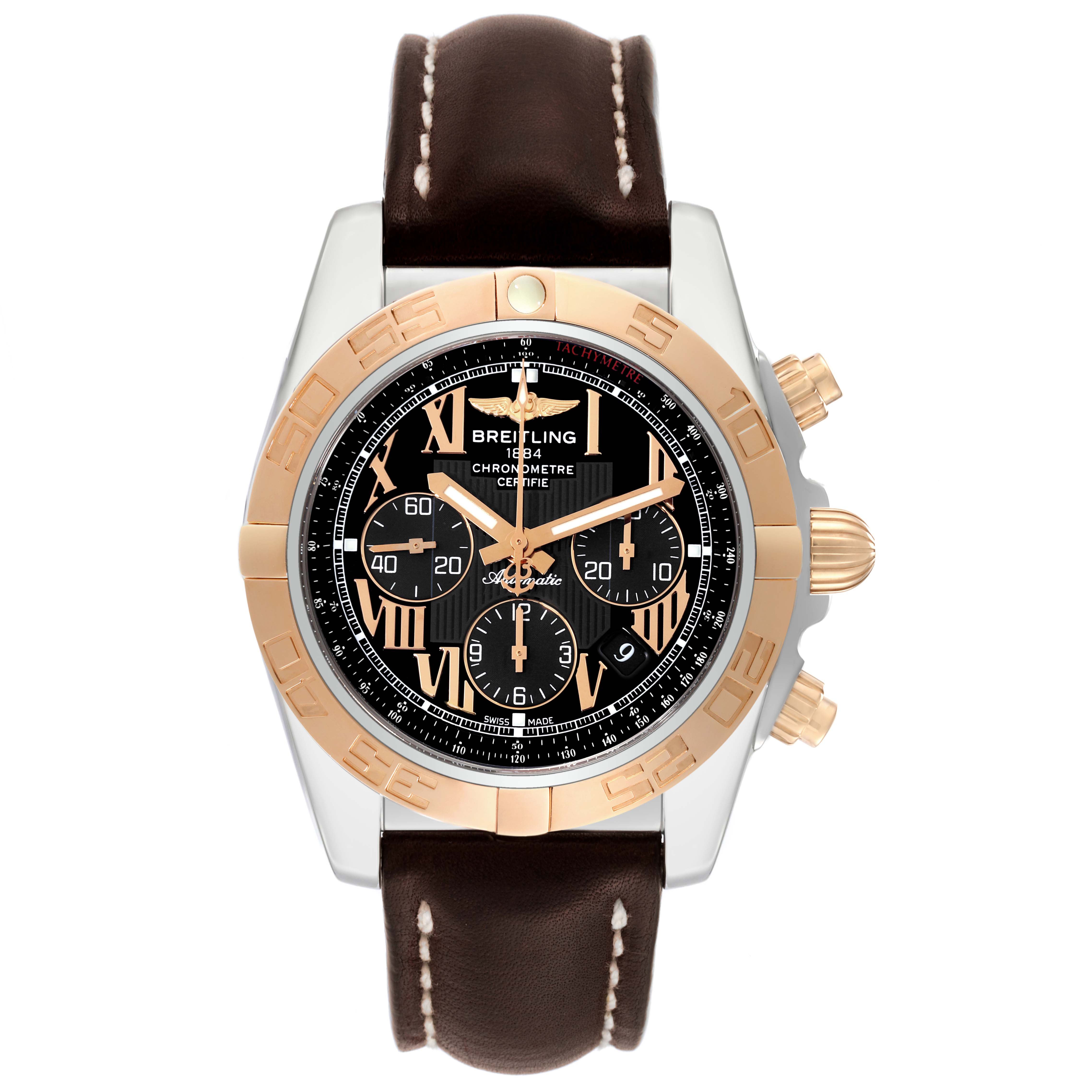 The image shows a Breitling Chronomat CB0110 Men's Steel and Gold (two tone) Black Dial CB0110 Men's Steel and Gold (two tone) Black Dial watch from a top view, highlighting its black dial, gold bezel, and brown leather strap.