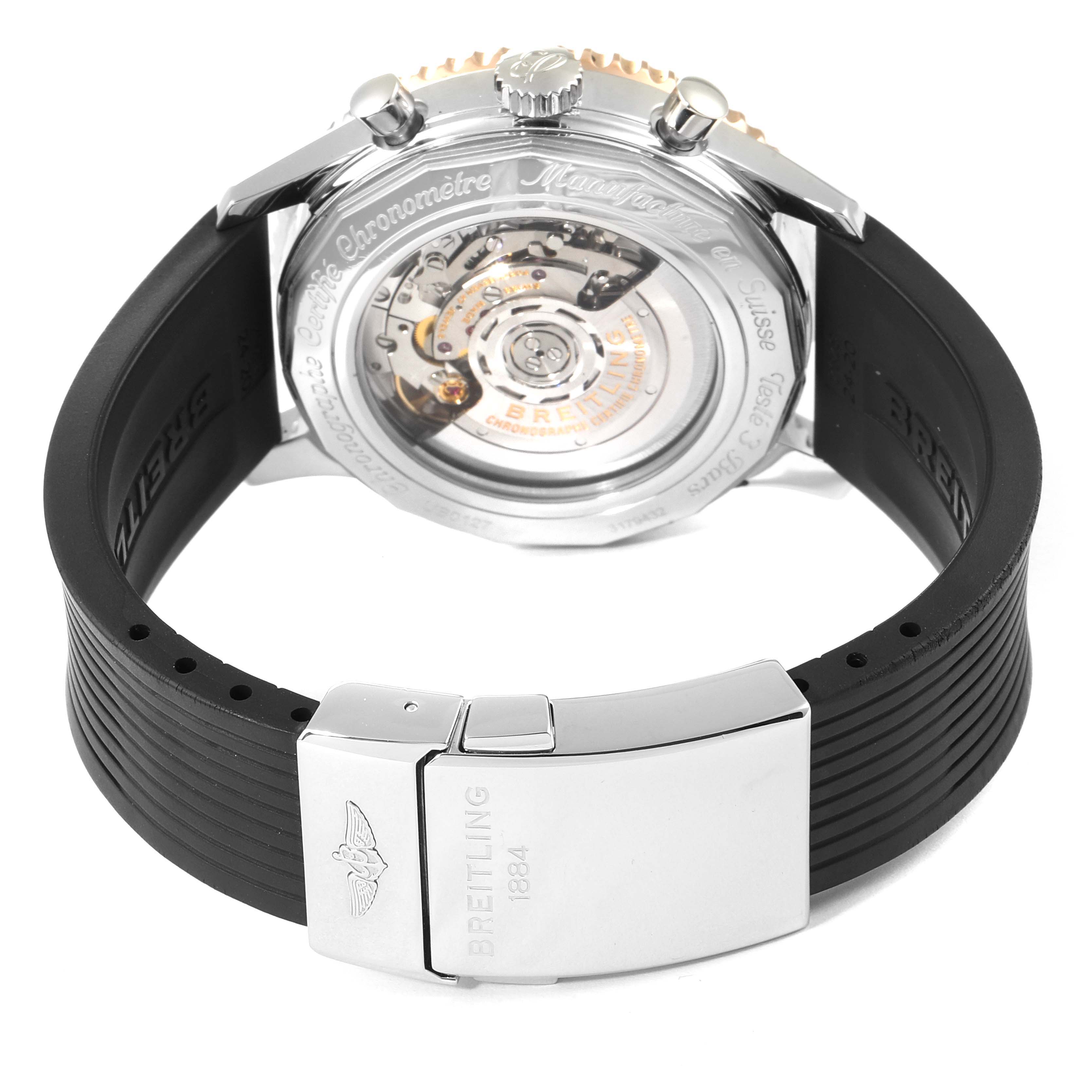 This image shows the back angle of a Breitling Navitimer UB0127 Men's Steel and Gold (two tone) Black Dial UB0127 Men's Steel and Gold (two tone) Black Dial watch, highlighting its movement and black strap with a clasp.