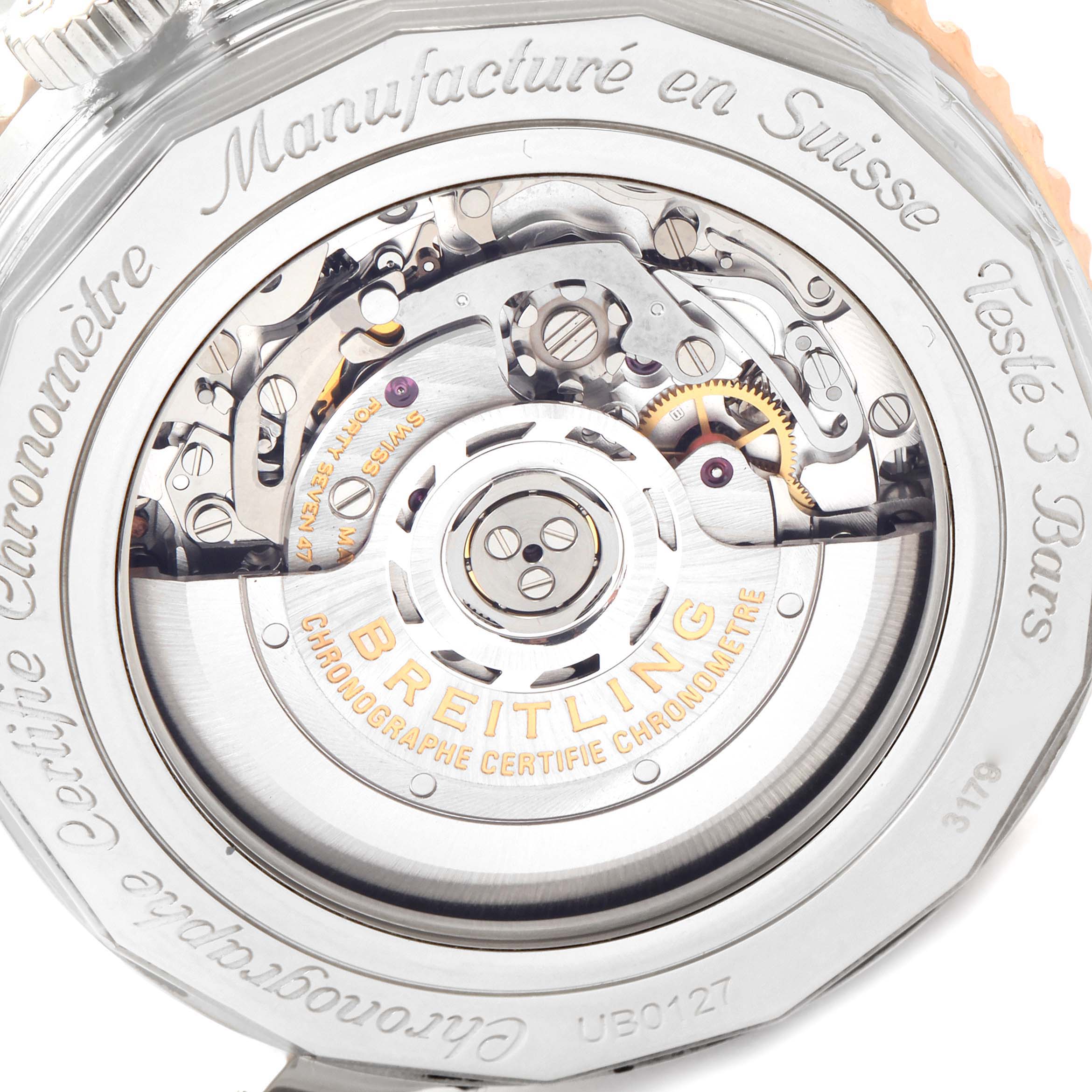 This image shows the open case back view of a Breitling Navitimer UB0127 Men's Steel and Gold (two tone) Black Dial UB0127 Men's Steel and Gold (two tone) Black Dial watch, revealing the inner movement and engravings.