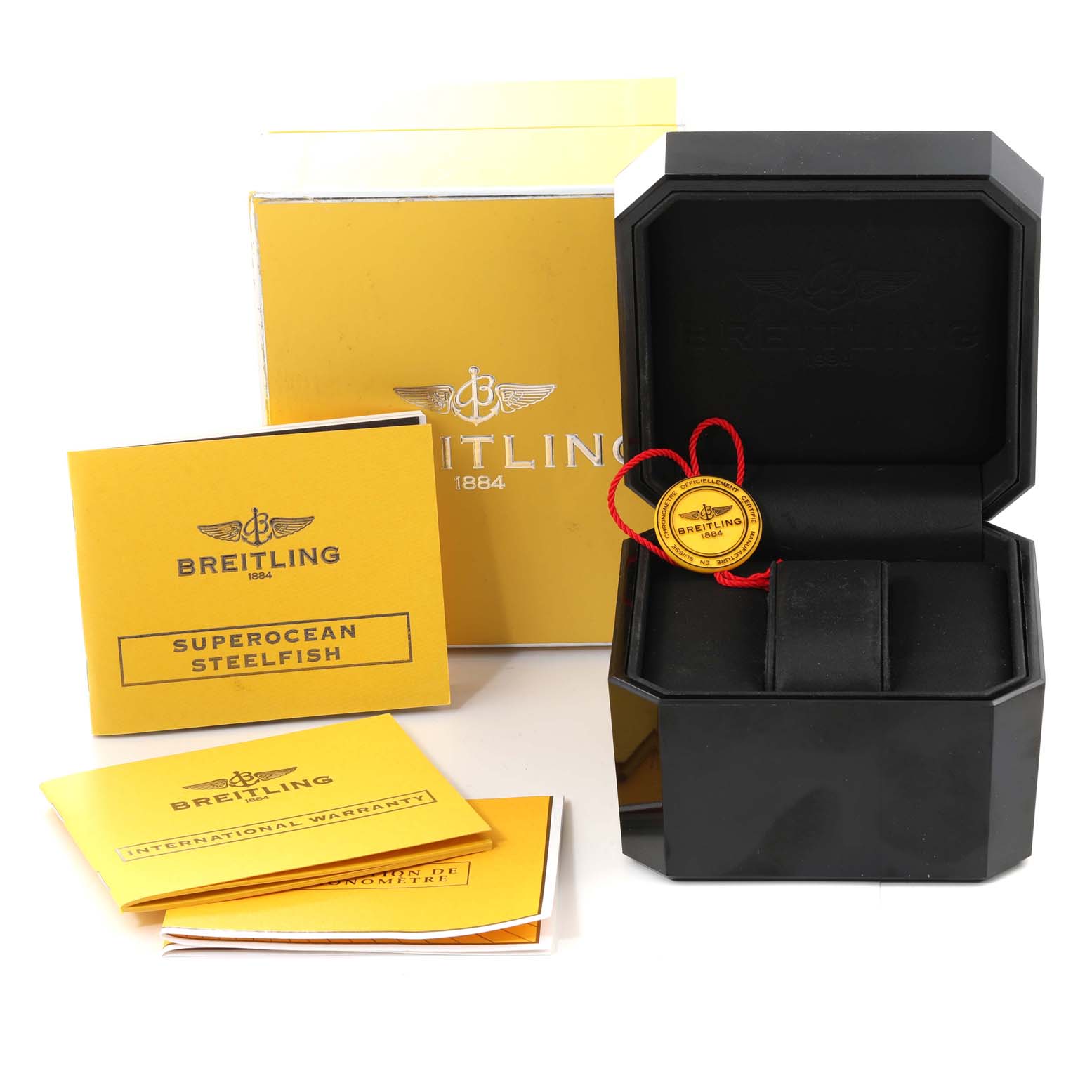 The image shows the packaging and accessories for a Breitling Superocean A17390 Men's Stainless Steel Blue Dial A17390 Men's Stainless Steel Blue Dial model, including the box, manuals, and warranty card.