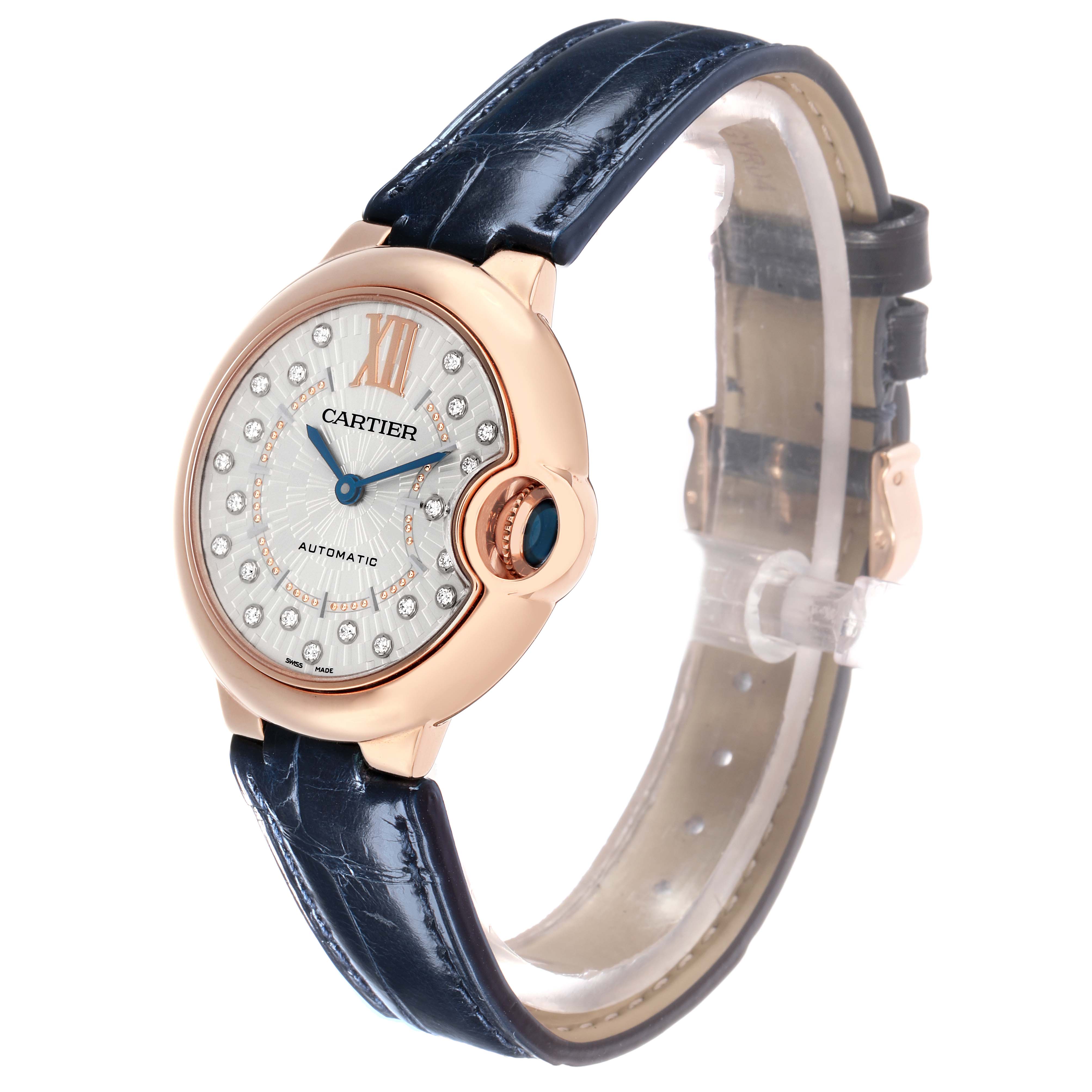 The Cartier Ballon Bleu WGBB0052 Men
s Rose Gold Silver Dial watch is shown at an angle highlighting the face, blue strap, and crown detail.