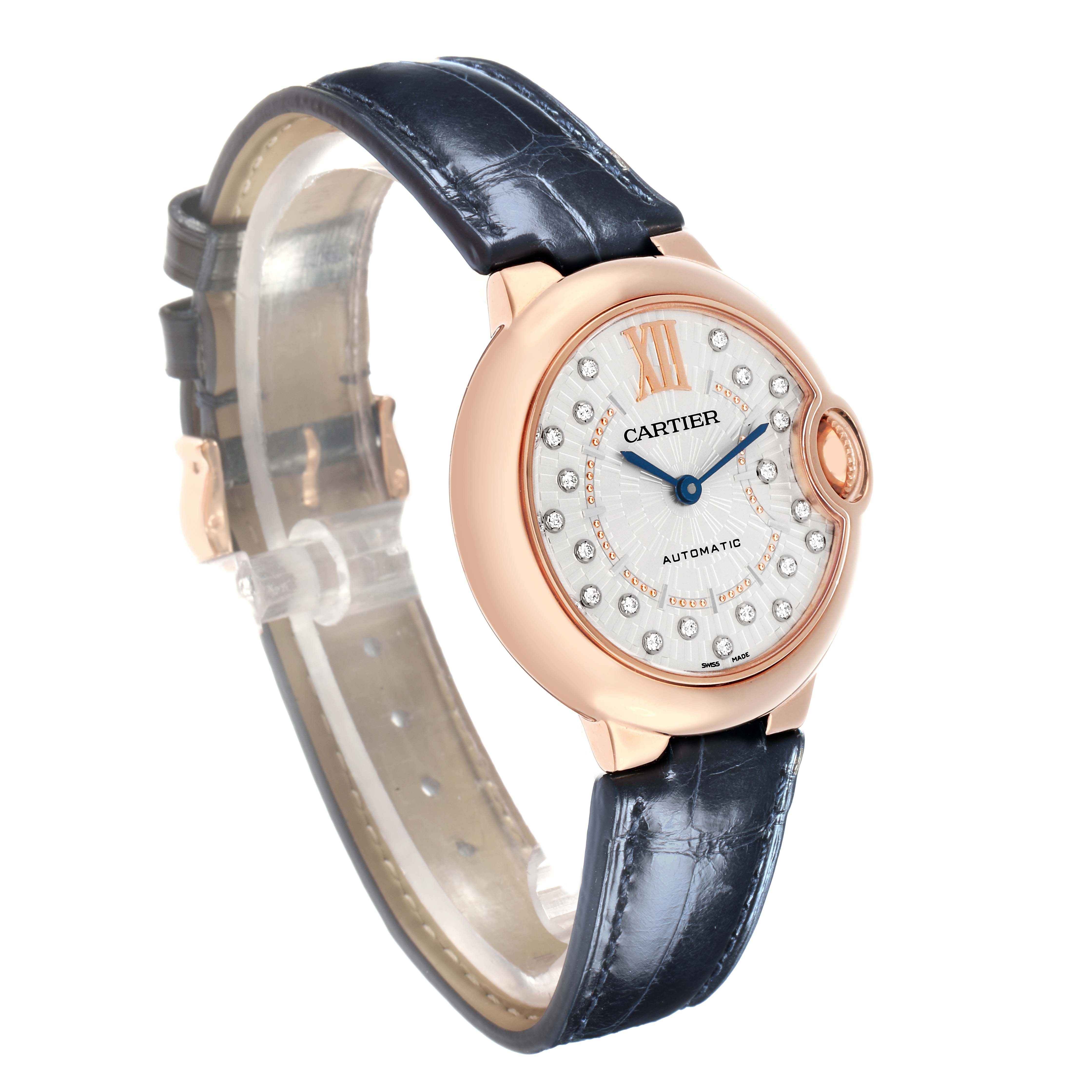 The Cartier Ballon Bleu WGBB0052 Men
s Rose Gold Silver Dial watch is shown at a slight angle, highlighting its rose gold case, diamond indices, and blue leather strap.