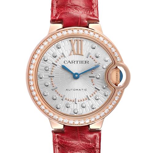The Cartier Ballon Bleu WJBB0080 Women's Rose Gold Silver Dial watch is shown from the front, highlighting its diamond-set bezel, silver dial, and circular case with a red strap.